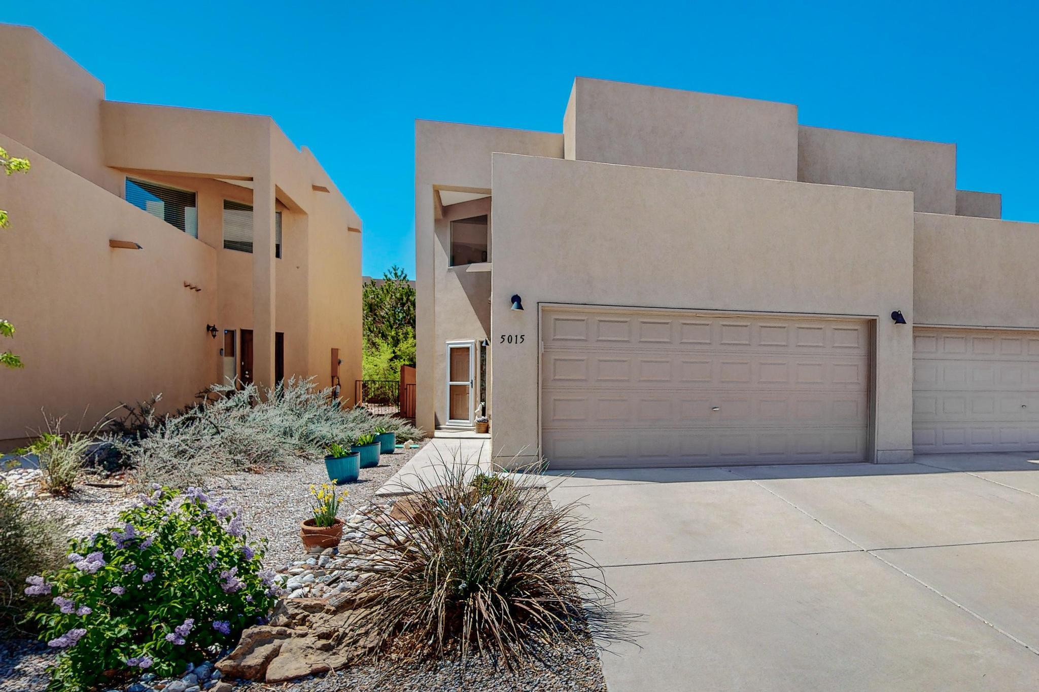 Beautifully updated townhome in a prime Northwest Albuquerque location. This open floor plan features tile and laminate flooring throughout, along with an upgraded kitchen complete with custom cabinetry, updated countertops, a stylish backsplash, stainless steel appliances, and a pantry. The dining area flows seamlessly into a spacious living room, where patio doors open to a private, beautifully maintained backyard with a remote-controlled awning ideal for shaded relaxation. All three bathrooms have been fully remodeled with modern vanities, updated fixtures, new toilets, and refreshed showers and tubs. Upstairs, a cozy sitting area provides the perfect spot to relax and take in scenic mountain views. The upper level also includes three well-proportioned bedrooms