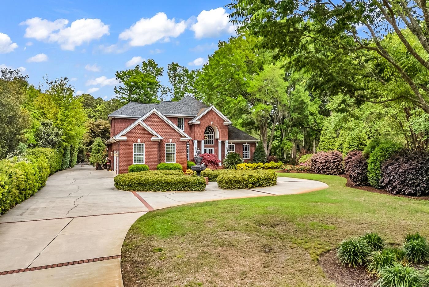 Nestled in the highly sought-after Waverly neighborhood of Pawleys Island, this stunning home offers a rare opportunity to experience peaceful living surrounded by natural beauty.  Situated along a serene canal, the property features a private floating dock and boat lift, providing quick and easy access to the Intracoastal Waterway and an exceptional boating lifestyle.  Designed with both family living and entertaining in mind, the home boasts a resort-style outdoor space complete with a beautiful in-ground pool, outdoor fireplace, and a fully equipped poolside kitchen - perfect for gatherings year round.  Inside, a grand winding staircase creates an elegant first impression.  The home also features a dedicated library or study with its own fireplace, offering a cozy retreat.  With four spacious bedrooms and four bathrooms, four fireplaces and multiple sitting areas, and a generous main living space, there is plenty of room for both relaxation and hosting guests.  Meticulously maintained and surrounded by lush landscaping, this property is ideal as a primary residence or a serene coastal getaway.  Come experience the best of Pawleys Island living - where comfort, nature and coastal charm meet.