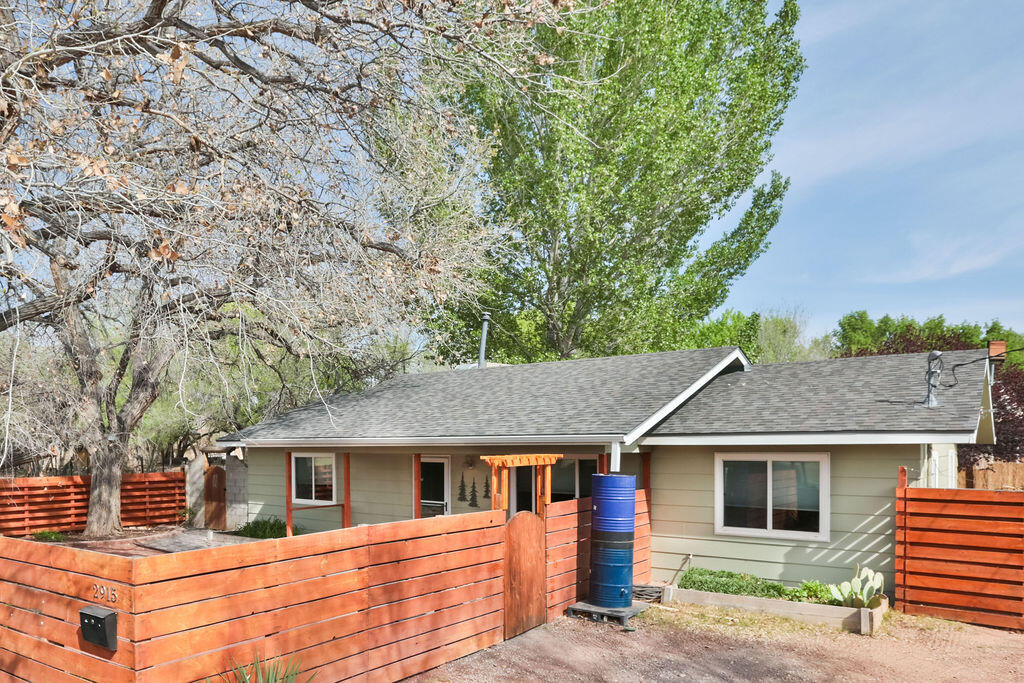 Your home awaits in the heart of the North Valley, nestled beneath a grove of mature cottonwoods and directly across from Duranes Park. This charming and inviting property welcomes you to slow down, relax, and embrace New Mexico time as you listen to the gentle breeze moving through the leaves.Inside, you'll find comfort and peace of mind with a new, warranted roof installed in 2026, along with several recent upgrades including a furnace (2024), Mastercool system (2026), seamless gutters (2026), and new flooring (2026). Thoughtful details throughout the home make it truly special--from the lovely built-ins to the artistically designed bathrooms featuring live-edge cottonwood and elm countertops, beautifully accented with inlaid turquoise that brings the outdoors in.