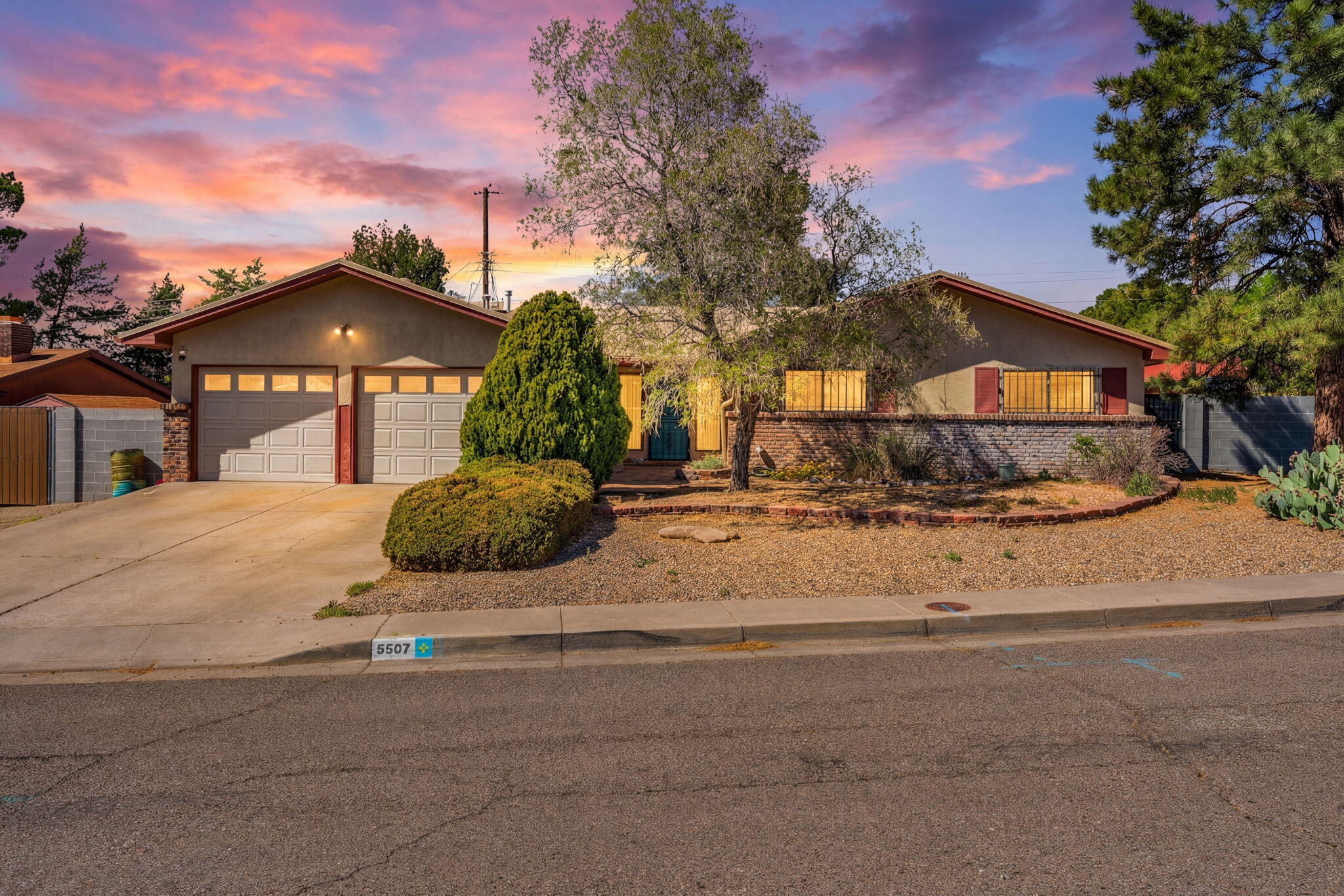 This beautifully upgraded and maintained home blends comfort, style, and thoughtful upgrades throughout with a new metal roof, block wall around the home! Sun-filled spaces highlight upgraded low-E windows, hardwood floors, custom trim, and a cozy fireplace anchoring the open living area. The updated kitchen features newer appliances and flows seamlessly for everyday living and entertaining. A spacious laundry/mudroom and built-in desk add function, while the owner's suite offers a large walk-in shower and custom closet with hardwood built-ins. Outside, the corner lot shines with eco friendly landscaping and multiple outdoor living spaces. New roof and central air add year-round comfort to this move-in ready home. See the upgrades list for all the upgrades by the seller!