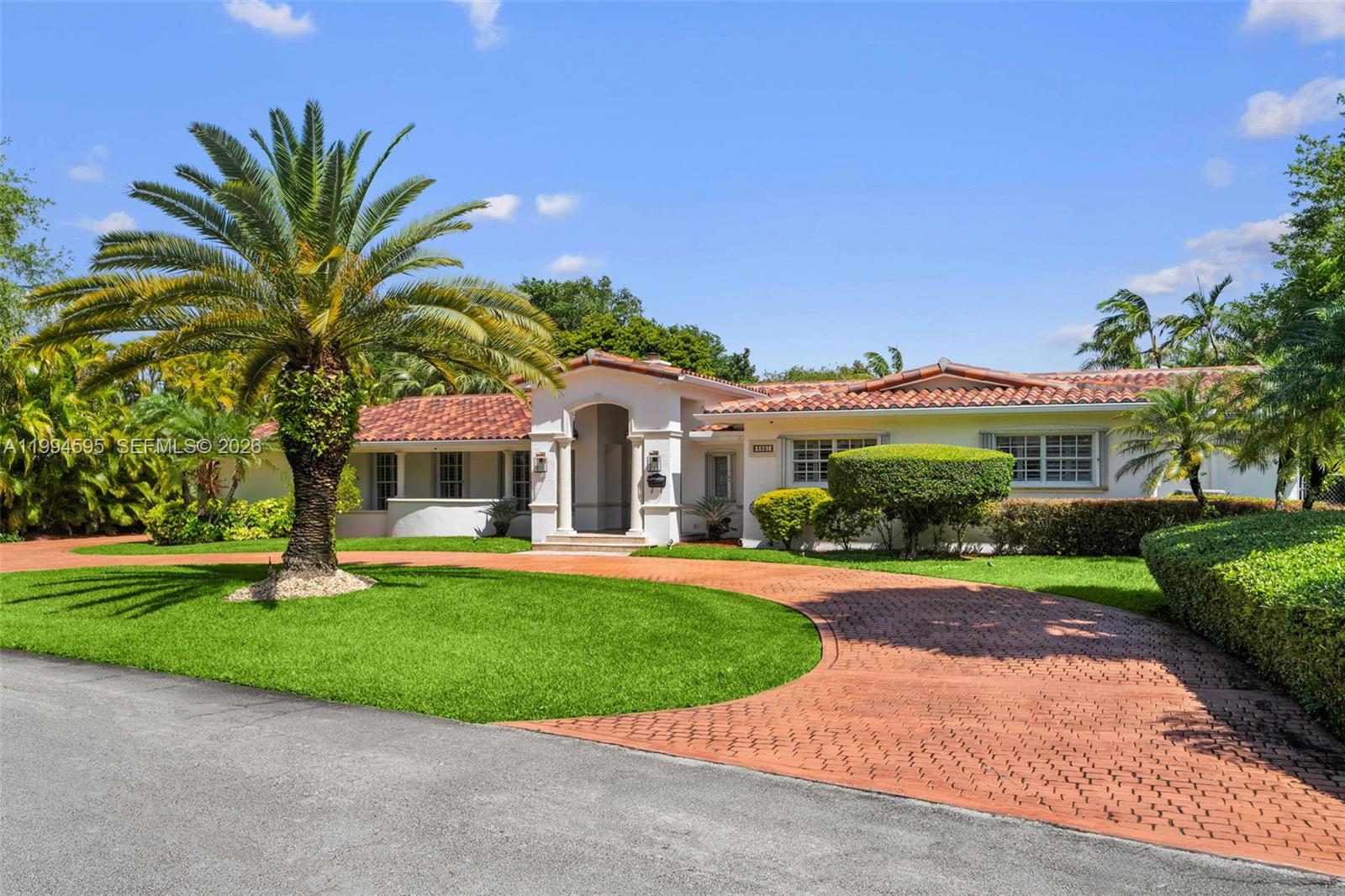 Located in the prestigious Pinecrest neighborhood, this 5BD/4.5BA residence sits on a 22,390 SF lot with soaring ceilings and open living spaces that flow effortlessly throughout. The chef’s kitchen features premium appliances and custom cabinetry, ideal for everyday living and entertaining. The primary suite opens directly to the backyard and includes a spa-like bathroom with separate vanities, a soaking tub, a glass-enclosed shower, and a walk-in closet with built-ins. The backyard provides a resort-style setting with a pool, covered terrace, and fully equipped summer kitchen, all surrounded by lush landscaping and perfect for outdoor entertaining. Additional highlights include a three-car garage, circular driveway, and ample parking.
