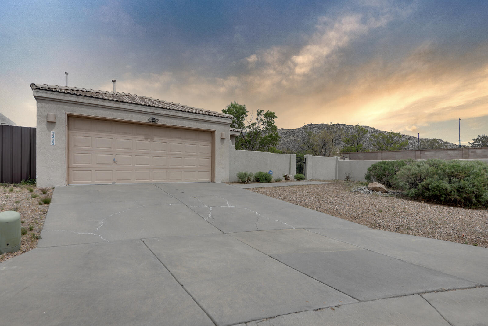 This bright and open home hosts tons of amazing features including large enclosed yard with gated front entry, hard surface floors throughout, and lots of natural light! As you walk in the front door you are greeted by a large living area with pellet stove and built in shelving wall. This connects with the kitchen with a large wrap around bar and eat in kitchen area. Kitchen has tons of cabinets and is ready for your creativity. There is a large sunroom or formal dining room off of the kitchen. Multiple sliding doors leading out onto yard and patio areas. Hosting a perfect floorplan with one bedroom and bathroom in the front of the home and another primary bedroom and on suite bathroom near the back of the home. Two car garage and large laundry room this house is move in ready! Perfect for