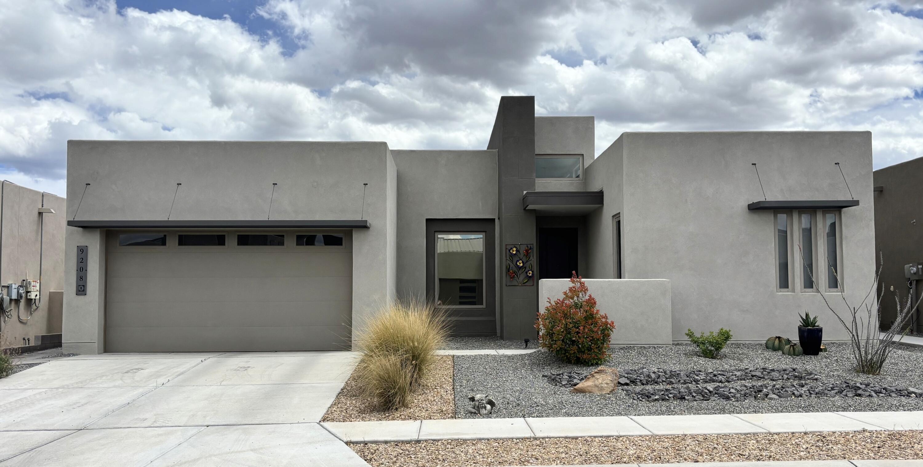 Stunning ''like new'' 2,598 SF contemporary masterpiece by Abrazo in sought-after Ascension neighborhood on a offers the pinnacle of Albuquerque luxury living. This home sits on a premium upgraded lot in the neighborhood.  Designed with a sleek, modern aesthetic and high-end finishes throughout, this 3-bed, 3-bath home seamlessly blends sophisticated style with everyday comfort. Chef-inspired kitchen serves as the heart of the home, with top-tier appliances and exquisite modern details. The spacious owner's suite provides a private retreat, while the additional bedrooms offer versatility for guests + extra gym/home office/flex space. The crown jewel of the property is the expansive rooftop deck, providing unobstructed, panoramic views of the Sandia Mountains.