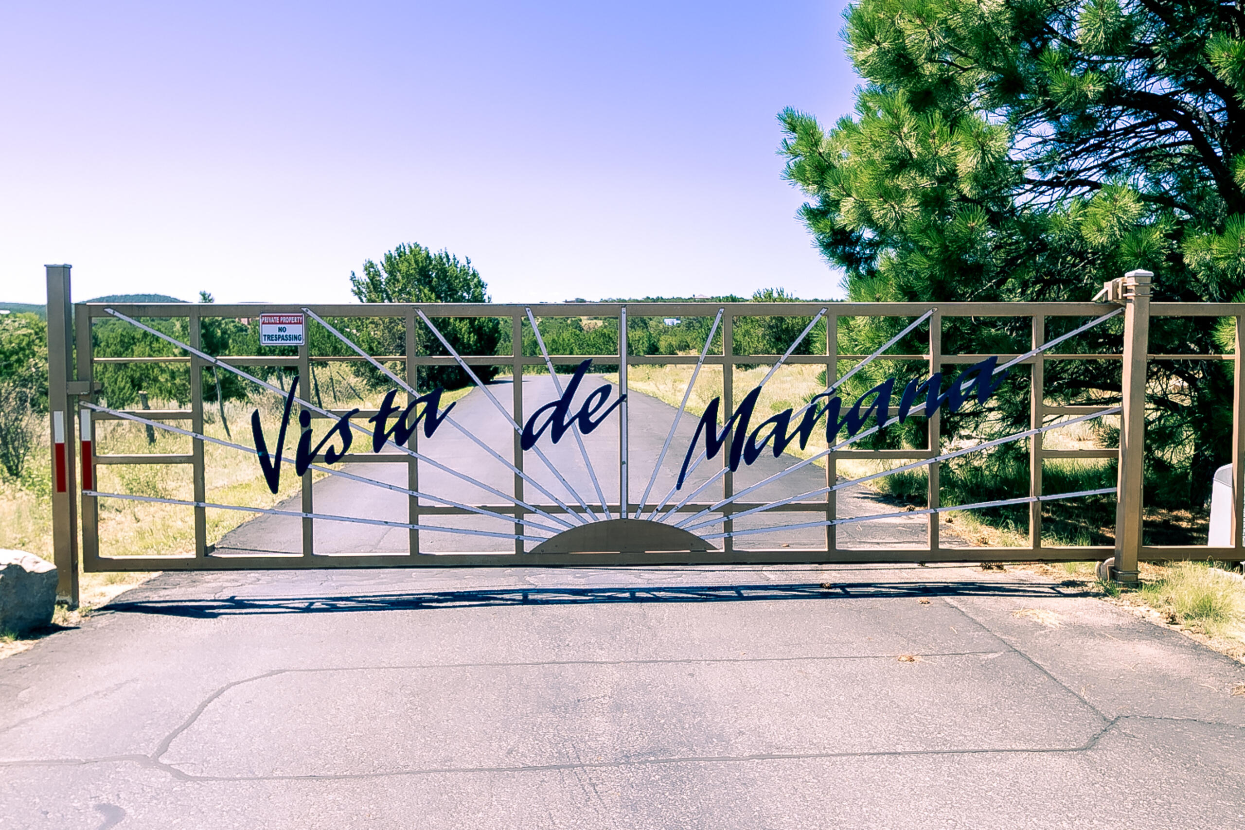 Custom-built Northern NM style home located in a gated community on a cul-de-sac w/ paved roads to the property and acres of subdivision common area behind the property. The home incls a pitched metal roof replaced in 2019, seller owned 9.6 kW solar system ~1.5 yrs old & energy-efficient mini-split systems throughout ~1.5 yrs old. The main level is constructed of adobe, providing thermal insulation & features stained concrete flooring. The kitchen incls shaker-style cabinets, under-cabinet lighting, updated granite countertops, a food prep island & a built-in pantry. The adjacent dining area offers built-in cabinetry & a china hutch w/ a butcher block countertop. The living room has a gas stove w/ a custom wood mantle.
