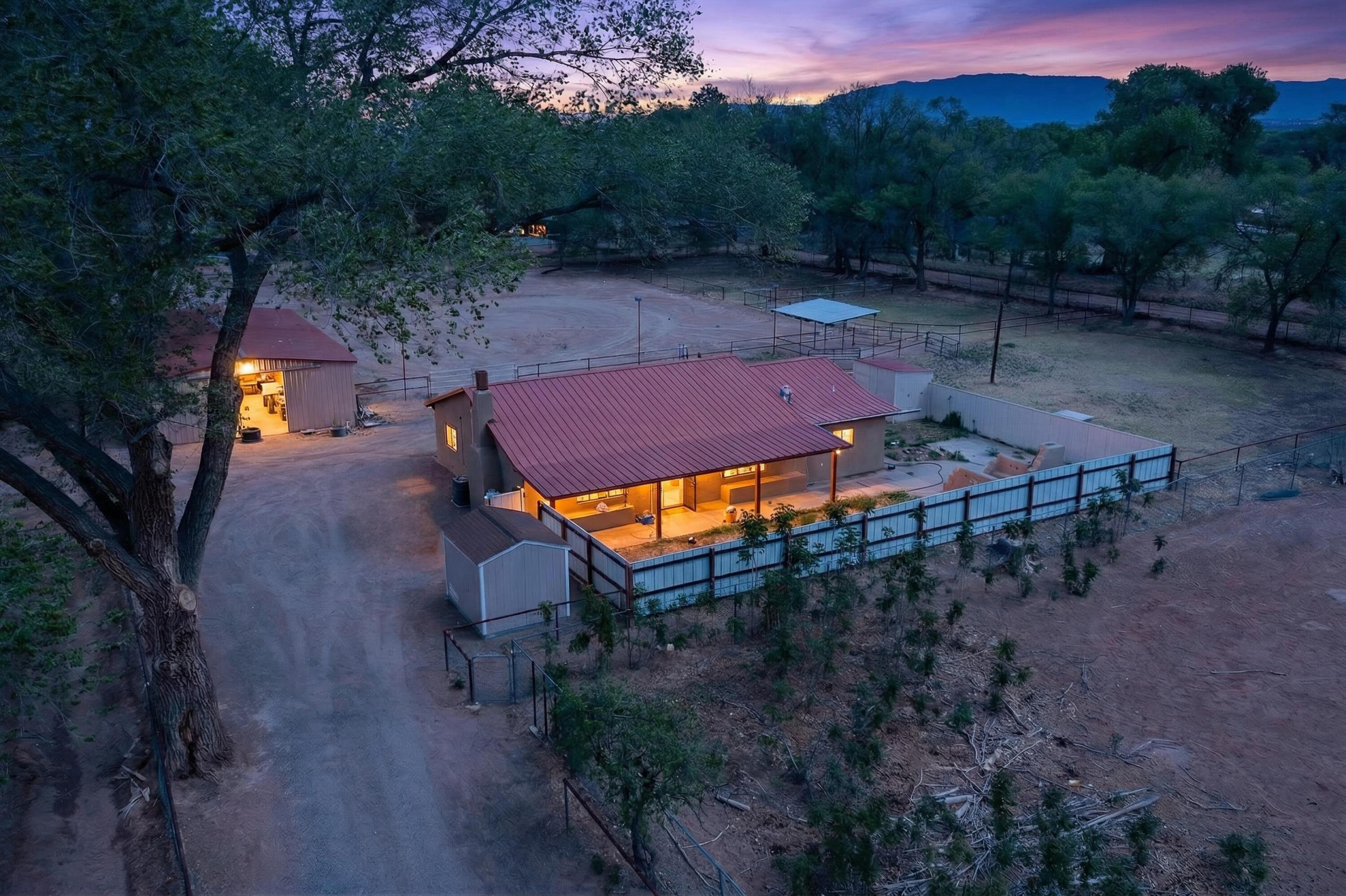 Discover your perfect blend of comfort and country living with this charming 3-bedroom, 2-bath home set on 1.74 acres. It is a peaceful horse property equipped with a three stalled barn tack room. Ample space for riding and access to ditch trails. Entertain under the stars by the inviting outdoor fireplace. Enjoy the home in the nicely finished kitchen, or large living room by unwind inside by the cozy wood-burning fireplace. Metal roofs, multiple storage sheds, city water and new Septic tank make this a great buy! Surrounded by quiet and open space, this home offers a warm, welcoming retreat with plenty of room to live, ride, and gather.