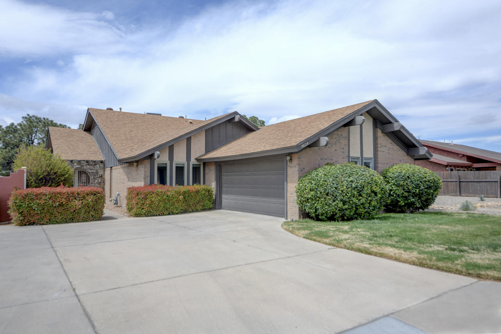 Located in a quiet enclave just north of the Arroyo del Oso Golf Course, this flexible home offers 2 bedrooms + office or 3 bedrooms, all with walk-in closets. The great room features cathedral ceilings and a custom fireplace. Primary suite opens to a private atrium. Kitchen includes a large pantry, and all appliances convey. Enjoy abundant storage, including attic space above the garage. Oversized garage with work area. Recent updates include newer roof, heating, and A/C. Pella windows throughout (except primary slider). Covered patio with roll-up awnings and gas hookup. Ideally located near Whole Foods Market, Smith's, Walmart, and Alb Academy.
