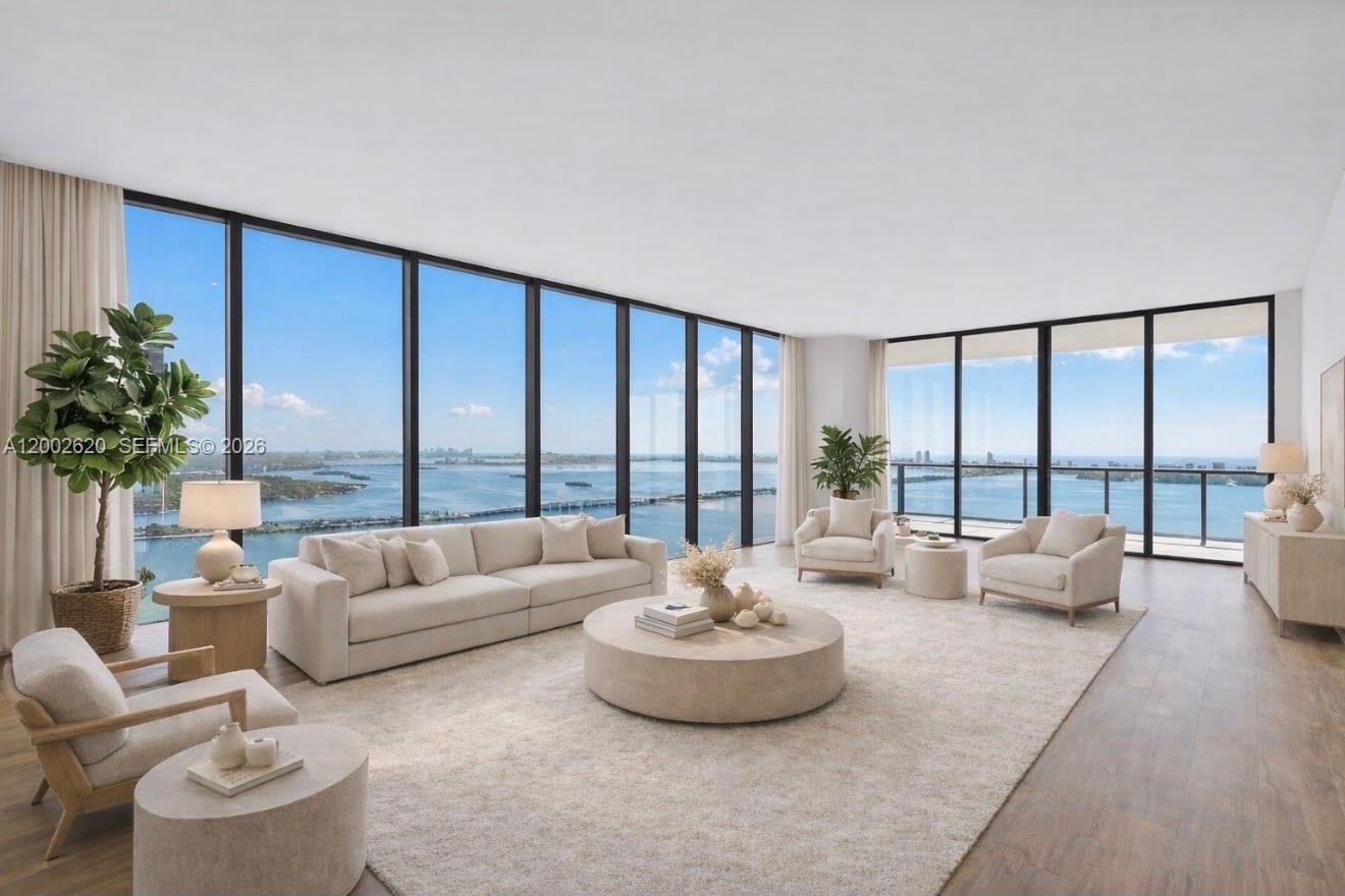 Located on the 48th floor of Elysee, this flow-through residence enjoys panoramic views from sunrise to sunset. Floor-to-ceiling glass and an east-to-west layout create a light-filled interior with open sightlines throughout. The living room, kitchen, primary bedroom and east-facing terrace overlook Biscayne Bay and the Miami Beach skyline, while the west-facing terrace offers expansive sunset and city views. The residence is accessed via a private elevator and foyer and features 4 bedrooms, 4.5 bathrooms, and a spacious den. The primary suite includes floor-to-ceiling windows, a spa-style bathroom with a large soaking tub, custom marble shower, and an oversized walk-in closet by California Closets. The kitchen is thoughtfully designed for both daily use and entertaining, featuring Italkraft cabinetry, Wolf and Sub-Zero appliances, and a gas cooktop. Well-proportioned living spaces and refined finishes provide comfort, functionality, and flexibility. Building amenities include sunrise and sunset pools, a state-of-the-art fitness center, a private owner’s lounge on the 30th floor, a children’s playroom, valet service, and 24-hour concierge. Offering privacy, generous living space, and full-service amenities, this residence is ideally positioned in one of Edgewater’s premier waterfront buildings.