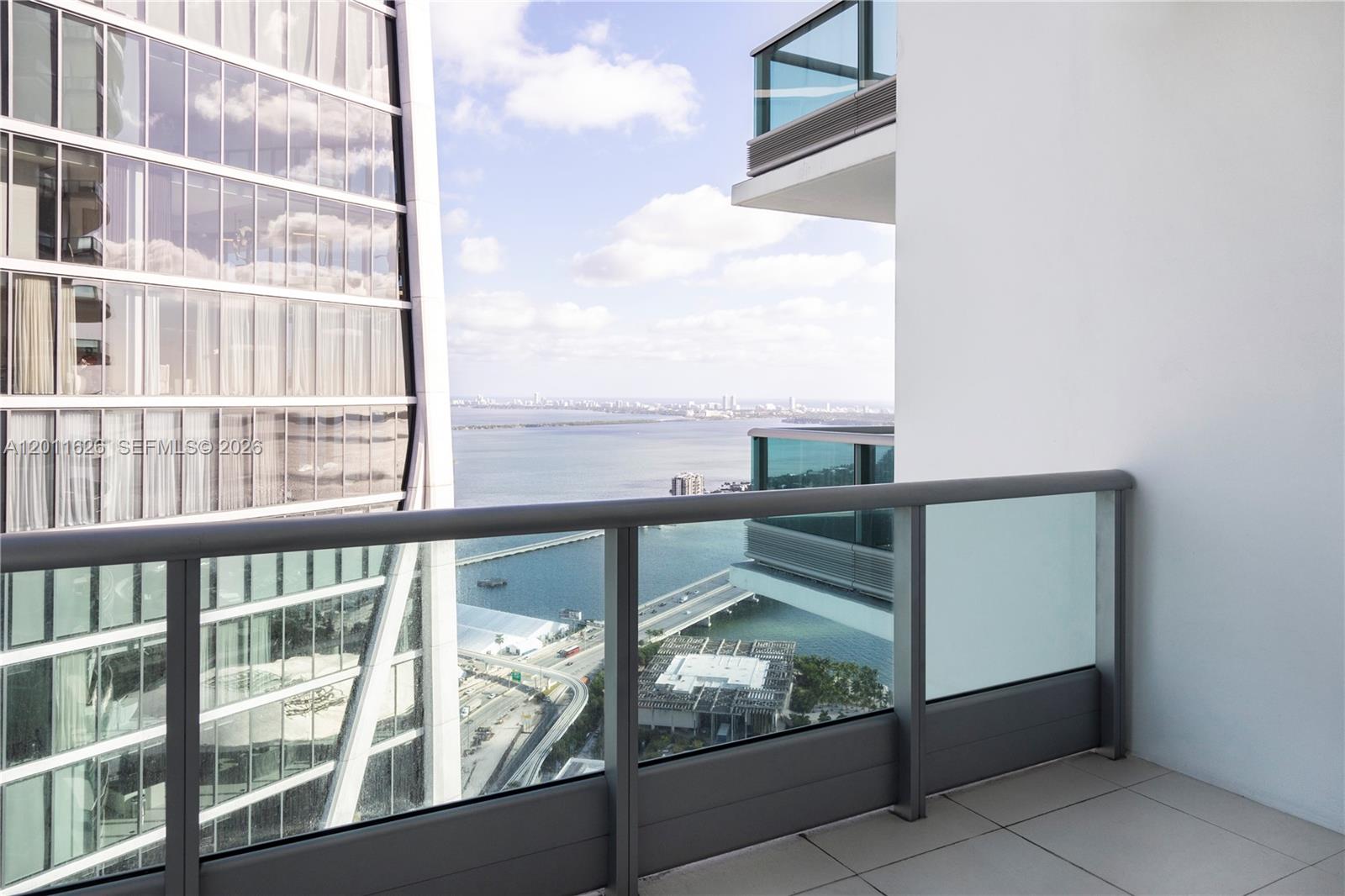 TENANT OCCUPIED UNTIL 5/31/27.Residence 5510 at 900 Biscayne is a beautifully reconfigured 1-bedroom plus den, now a spacious 2-bedroom, 2-bathroom residence, positioned on the 55th floor with sweeping panoramic views of Biscayne Bay and Miami’s skyline. Floor-to-ceiling windows and high ceilings flood the space with natural light, while white glass tile flooring adds a clean, modern finish throughout.The open kitchen is equipped with premium Sub-Zero and Miele appliances, complemented by high-end cabinetry and sleek finishes. The primary suite offers a custom walk-in closet, a spa-style bathroom, and direct access to one of two oversized balconies, enhancing the indoor-outdoor living experience.900 Biscayne delivers a full-service lifestyle with resort-style amenities including two pools, a state-of-the-art fitness center, spa with steam, sauna and jacuzzi, private movie theater, club room, children’s playroom, concierge, and 24-hour valet. Cable and high-speed internet are included in maintenance. Ideally located across from Bayfront Park and Pérez Art Museum, this residence combines elevated design, premier amenities, and an exceptional waterfront location.