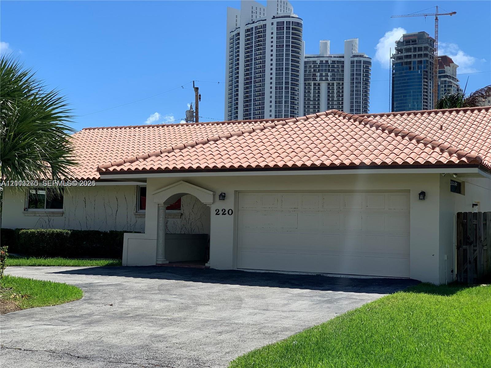 Stunning one-story home ideally located in the heart of Sunny Isles Beach, just a short walk to the ocean. Nestled on a prime lot in a prestigious multi-million dollar neighborhood, this beautifully remodeled residence offers the perfect combination of modern design and coastal living.Featuring high-volume ceilings and skylights, the home is filled with abundant natural light, creating a bright and airy atmosphere throughout. The modern kitchen is thoughtfully updated with sleek cabinetry and stainless steel appliances, ideal for both everyday living and entertaining.Spacious living areas flow seamlessly, while built-in closets provide ample storage. A two-car garage adds convenience and functionality. Enjoy the best of South Florida living in this exceptional location, just moments from the beach, fine dining, and world-class shopping.A rare opportunity to own a stylish, move-in ready home in one of the most desirable areas.
