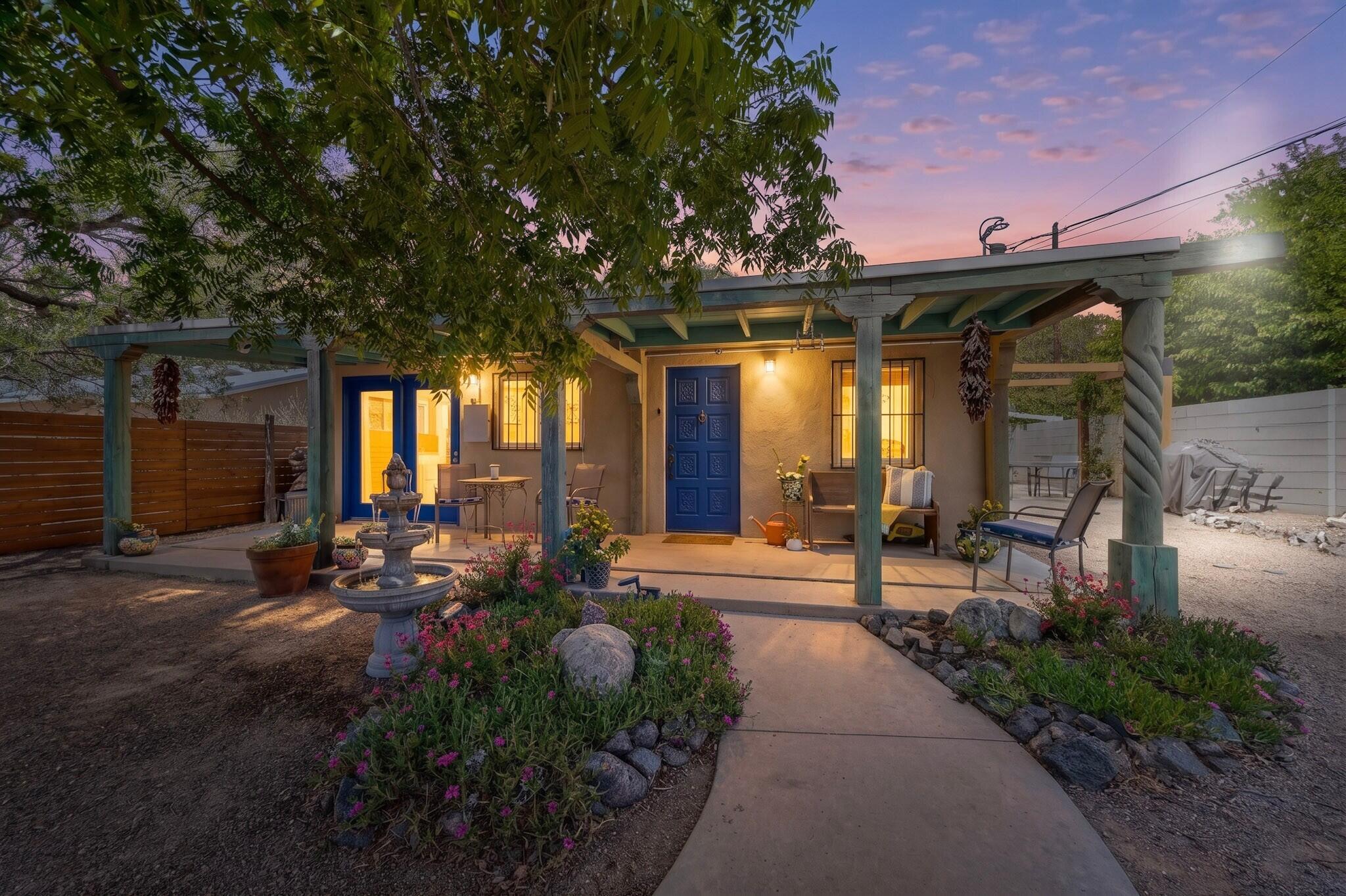 Duranes Hidden Gem filled with NM charm updated for modern convenience! Enter into a gorgeous, private, fenced courtyard oasis w/SW landscaping, fruit trees & large covered porch with views of the Sandia's. Inside you will find adobe walls, kiva fireplace, beautiful Mexican talavera tile accents, tin ceiling in living room, with stunning bar perfect for coffee station & entertaining w/built in shelving, bar sink and wine fridge. Kitchen has hickory cabinets, quartz CT, island with storage, all newer appliances & convenient pot filler at stove. Both bathrooms updated. New flooring & lighting throughout. Newer mini split system and TPO roof with transferable warranty. Plus solar for low energy bills! Gated parking area. Great location off Rio Grande near shopping, dining & Nature Center.
