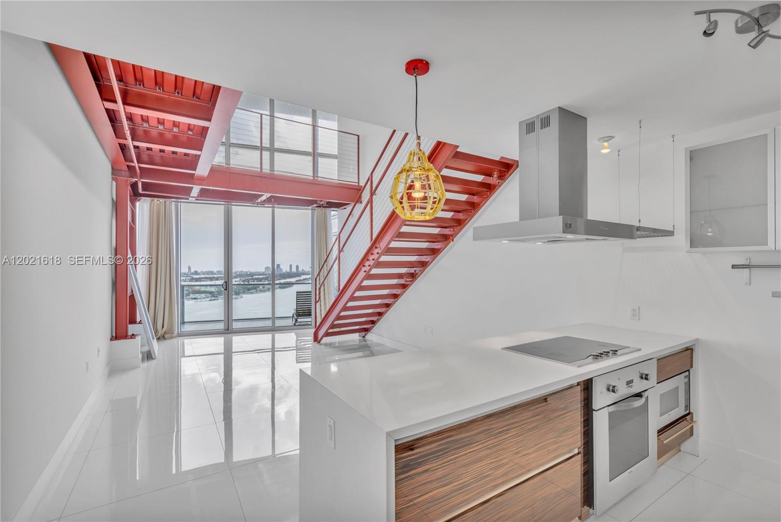 Experience breathtaking oceanfront views from this one-of-a-kind loft residence at Marquis Condo in the heart of Miami. Enjoy complimentary beach services at Bentley Beach Club in South Beach. This unit offers over 1,900 SqFt of living space, including 200 additional SqFt compared to other units in the same line, all completed with permits. A custom steel-and-wood mezzanine creates the ideal library or office space. The redesigned staircase was thoughtfully relocated to accommodate an oversized primary closet, and the enclosed den has been converted to function as a second bedroom, featuring its own walk-in closet. Additional highlights include a spacious laundry room, exposed brick accent wall, assigned parking space, and a private storage unit. Perfectly located directly across from the Pérez Art Museum Miami and a waterfront park, this residence is just minutes from South Beach, the Miami Design District, Brickell, and Miami International Airport. The building offers luxury resort-style amenities, including an in-house hotel, spa, restaurant, basketball court, and top-tier resident services. Freshly painted and move-in ready.