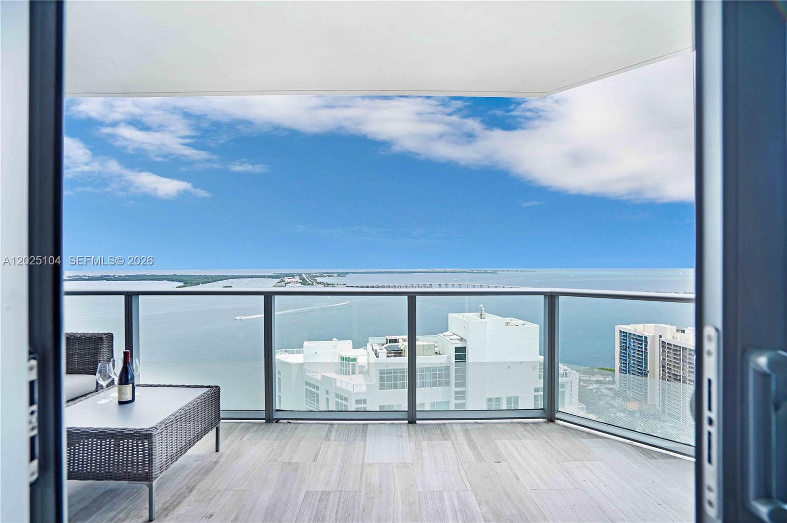 Stunning corner residence at Brickell House with breathtaking panoramic Biscayne Bay and Miami skyline views. This bright and spacious 3-bedroom, 2 and 1/2-bathroom residence features floor-to-ceiling windows, a modern open layout, marble floors, and a sleek gourmet kitchen. The primary suite offers a walk-in closet and spa-style bath, while the expansive wraparound balcony showcases spectacular sunrise and sunset views. Includes private storage unit and assigned parking. Enjoy luxury resort-style amenities including rooftop pool, fitness center, spa, theater room, concierge, and valet. Prime Brickell location just steps from the waterfront promenade, top restaurants, nightlife, and minutes from Downtown Miami, Brickell City Centre, and Key Biscayne. Move-in ready