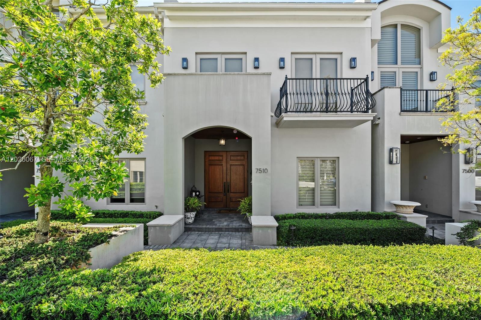 Live the luxury life of ease in the Townhomes at Oak Lane, a gated High Pines community bordering lively, supremely walkable Downtown South Miami. This meticulously maintained home is strikingly appointed with travertine marble & wood plank floors + an elevator to whisk you between all 3 levels, which include a fully finished walk-out basement. Entertain indoors or out, inviting guests to mingle thru distinct formal and casual wings that flow out to a private walled patio adorned with lush, mature landscaping. The secluded primary suite features a large, multi-room spa-inspired bath, 2 large closets & a big balcony. Also boasting impact windows & doors, an automatic generator, laundry & 4 garage spaces, this home will exceed your expectations. Located in Sunset Elementary School District.