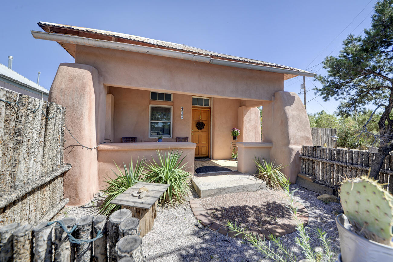 Spectacular Old Town Adobes on .25ac  - Two Homes on One Property! A rare opportunity to own two lovingly restored adobe homes, showcasing authentic New Mexican charm and timeless character. Each home has been thoughtfully updated with respect for the original features. The homes features thick adobe walls, wood floors, vintage light fixtures and updated kitchens and bathrooms. Old Town charm is everywhere you look, from the bell above the Lomas home, the ristras, vintage wagons, custom tin outdoor lights and carved tree with Our Lady of Guadalupe. Endless possibilities for live or work combinations. Currently used as successful airbnbs, but have previously been an an art studio, small private school and a jewelry shop. Private gated entrance with ample parking. New roofs installed 4/26.