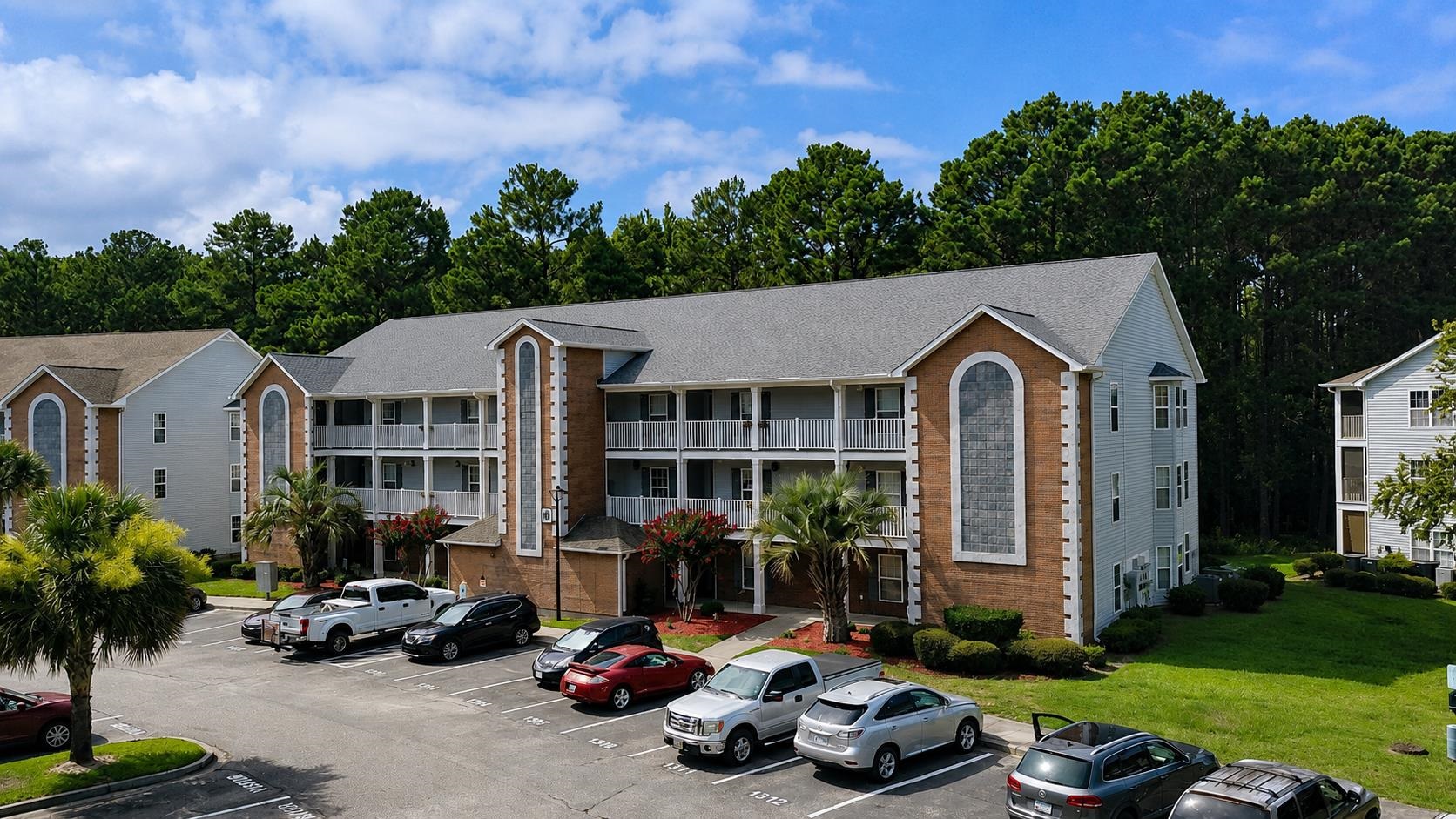 Your Opportunity just got better! Welcome to easy coastal living in this first-floor unit, offering the perfect blend of privacy, comfort, and convenience. Overlooking a peaceful, tree-lined green space, this home provides a serene setting to unwind. Relax on the oversized screened porch with direct access to the community lawn, perfect for morning coffee or walking the dog.  Inside, this spacious 3-bedroom, 2-bath home features durable luxury vinyl plank flooring throughout the main living areas, creating an inviting space that is ideal for entertaining. Major updates provide peace of mind, including a new HVAC system installed in 2023 (transferable warranty), plus a new dishwasher and dryer in 2025 along with a new water heater in 2026.  All appliances and window treatments convey.  Perfect as a primary residence, second home, or investment opportunity, this move-in ready home delivers comfort, convenience, and a tranquil setting you'll love coming home to.