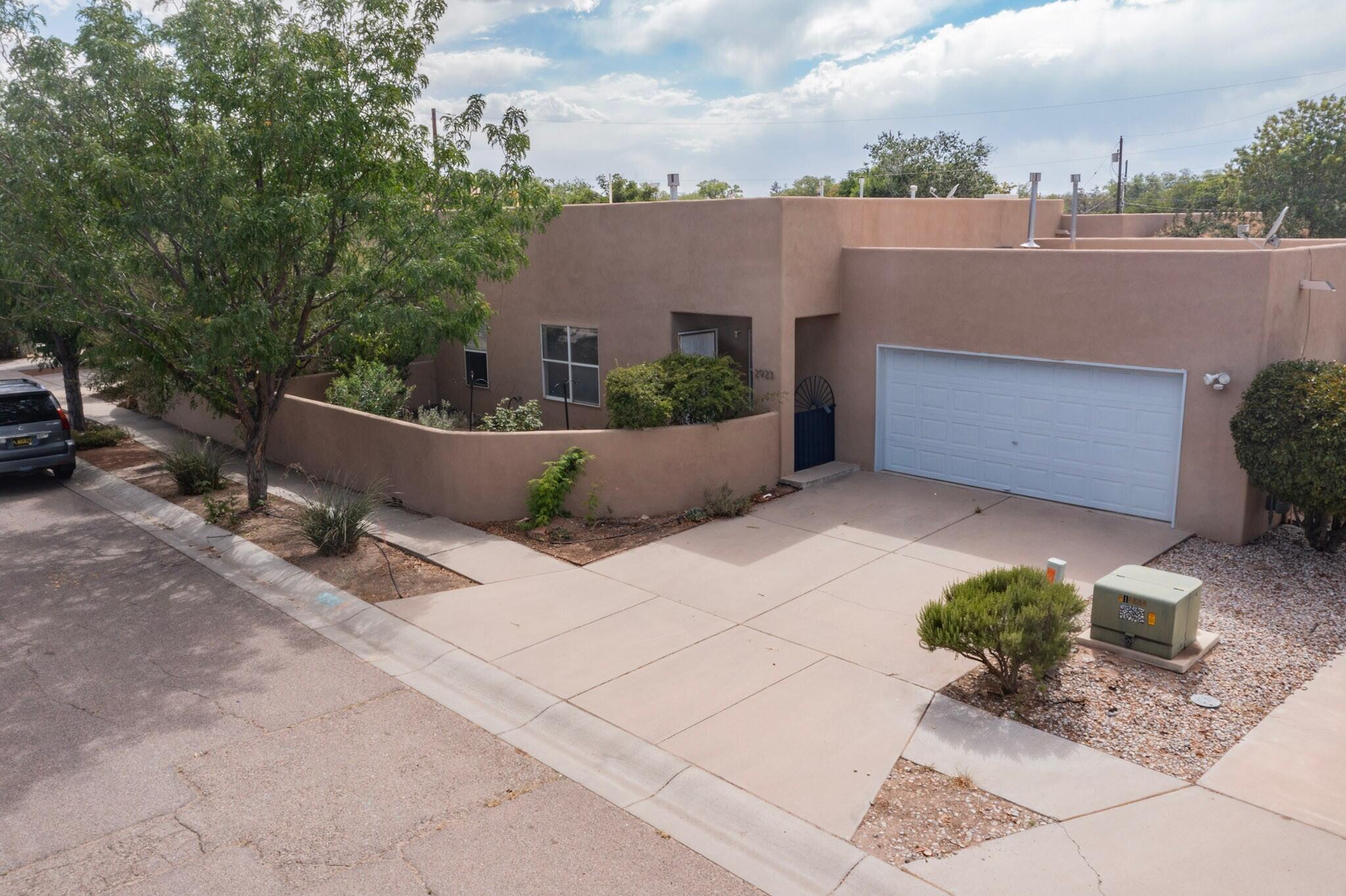This light and bright townhouse is in a hidden gem of a neighborhood in the heart of Albuquerque.  It has granite countertops and stainless steel appliances and new flooring throughout. Perfectly quiet cul de sac living across from Los Tomases Park. Enjoy the view of the Sandias from the landscaped courtyard.  Easy to maintain front and backyards with drip systems. Close to I40 and I25, downtown, biking trails.  NO HOA.  The oversized 2 car garage is a bonus.  Enjoy the gas fireplace on chilly nights. Open and easy floorplan