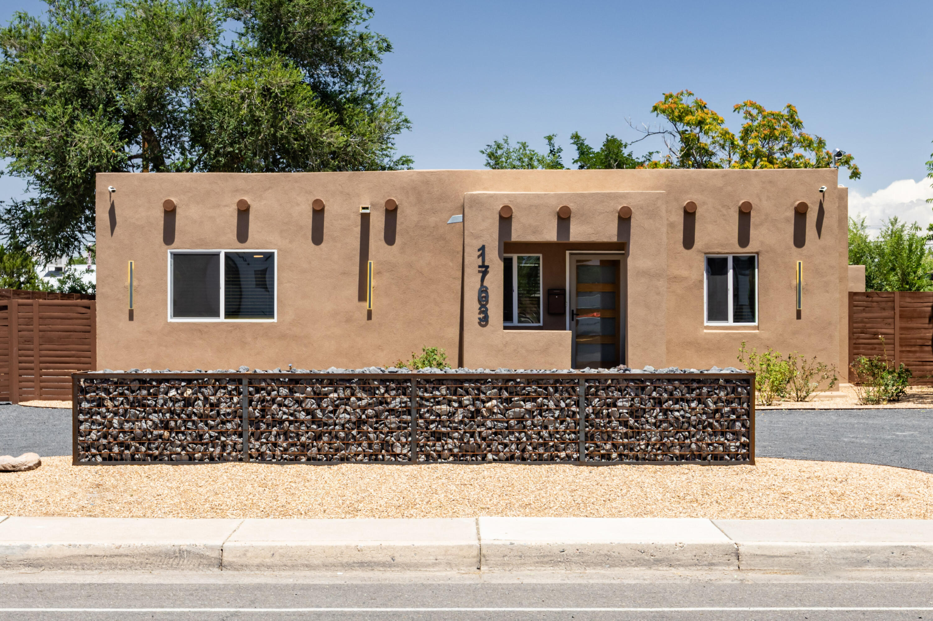Thoughtfully renovated and full of character, this 1936 adobe home sits on a spacious lot in Albuquerque's historic North Valley. Blending timeless architectural charm with modern updates, the home offers the best of both worlds. The expansive kitchen features an impressive 10' x 6' center island, quartz countertops, custom-built hardwood cabinetry, under-cabinet lighting, abundant storage, and modern appliances. Major improvements include a new roof, thermal-pane windows, new stucco, and refrigerated A/C. Both bathrooms have been completely renovated with new plumbing, fixtures, tile, and lighting. An oversized utility room provides additional storage and functionality. The property also includes a private detached studio or flex space, rear access, and plenty of room for