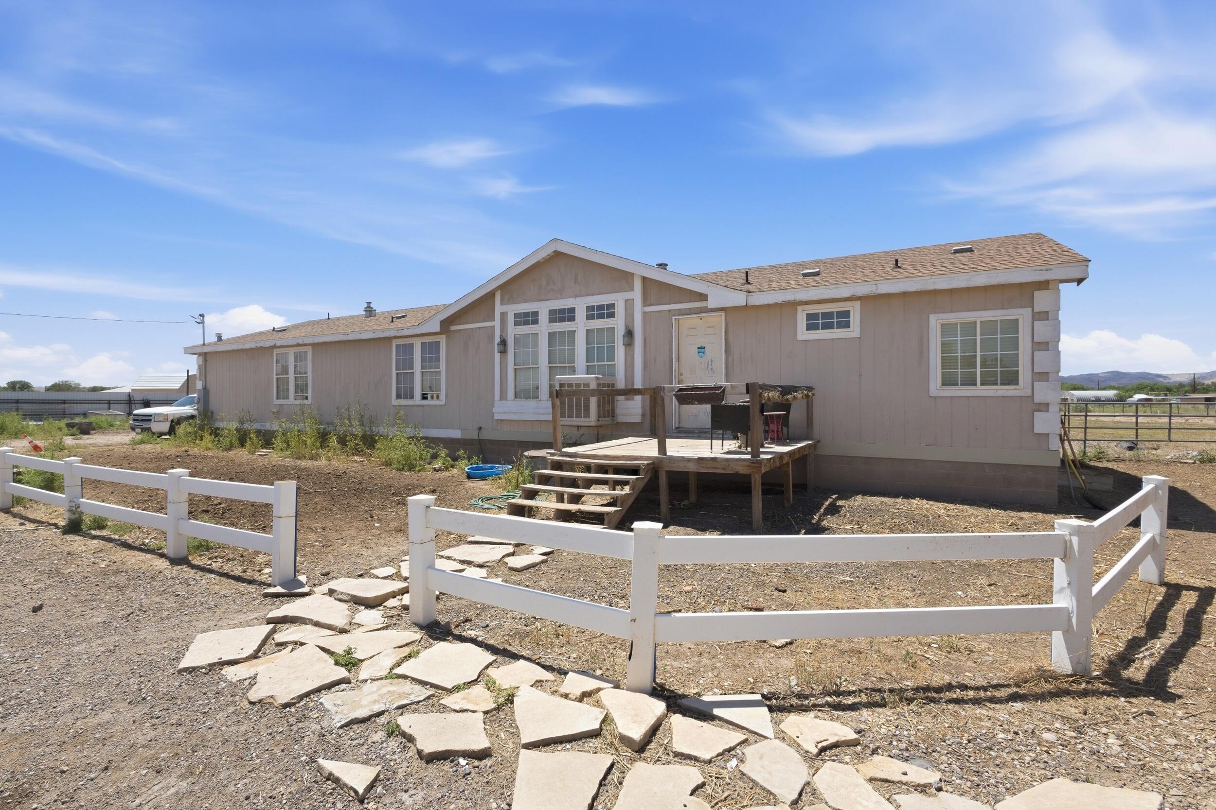 Enjoy peaceful country living on a full acre in Los Chavez, just minutes from Los Lunas! This well-maintained manufactured home offers plenty of space to spread out, with room for horses, RVs, toys, or future projects. Enjoy the privacy of rural living while staying close to shopping, dining, schools, and I-25 for an easy commute. A great opportunity to own acreage with convenience! Needs TLC Investor special!