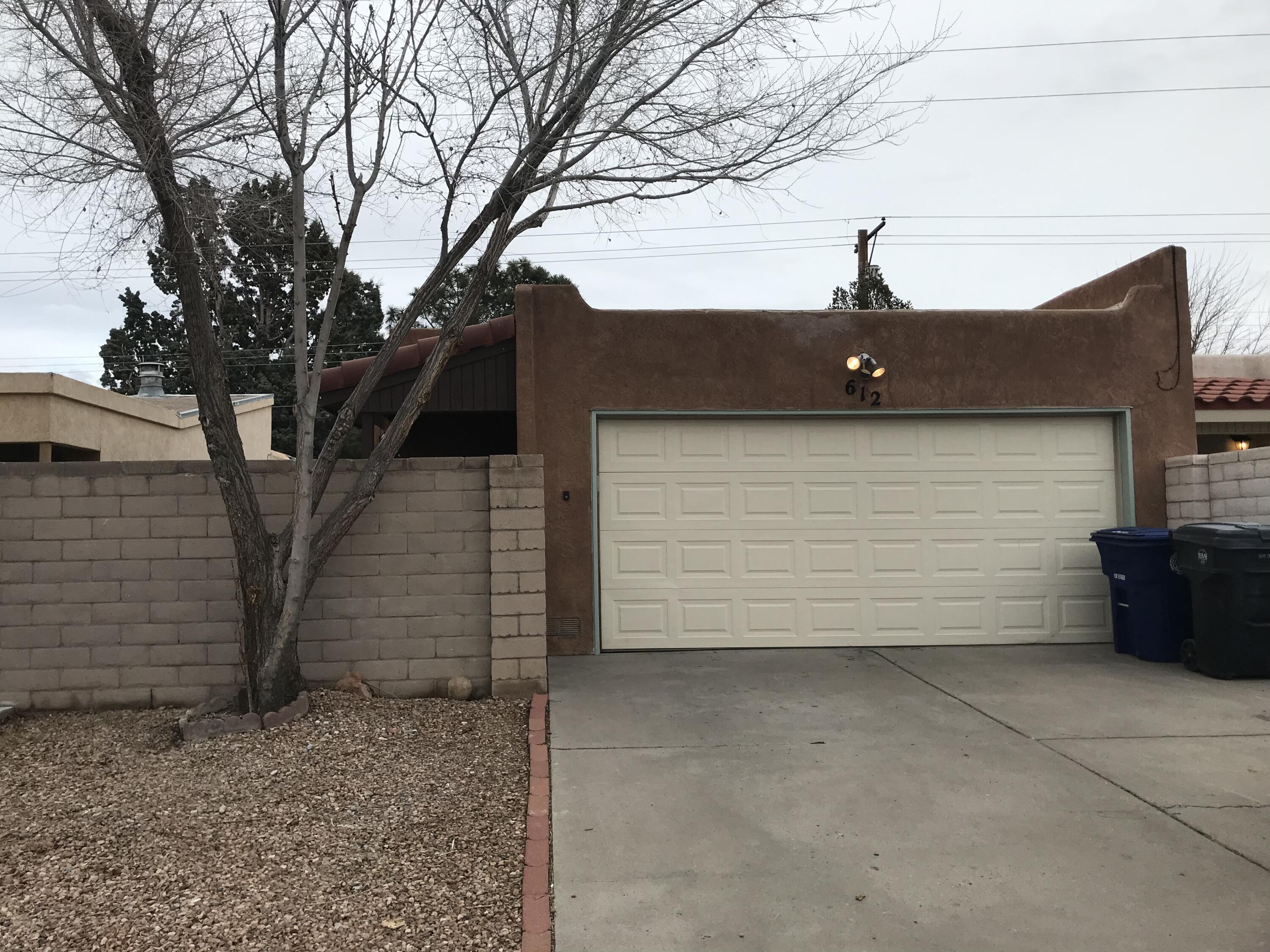 Welcome to this very nice and great priced, freshly painted move-in ready 2 bedroom, 2 bath townhome in Fair West. The open floor plan includes a large kitchen and a living room with large fireplace. Two skylights in living room pour in abundant New Mexico light. Freshly painted throughout. The kitchen could use some updating, yet the cabinets are refinished, has newer refrigerator and dishwasher, and brand new electric stove and microwave. All tile floors throughout the house. Master bedroom opens into the private back yard. Large two car garage. The TPO roof was installed in 2018 and is still under warranty. New xeriscape landscaping front and back. The house has HVAC. Great access to shopping, Nob Hill, Uptown, the UNM area and Kirtland.