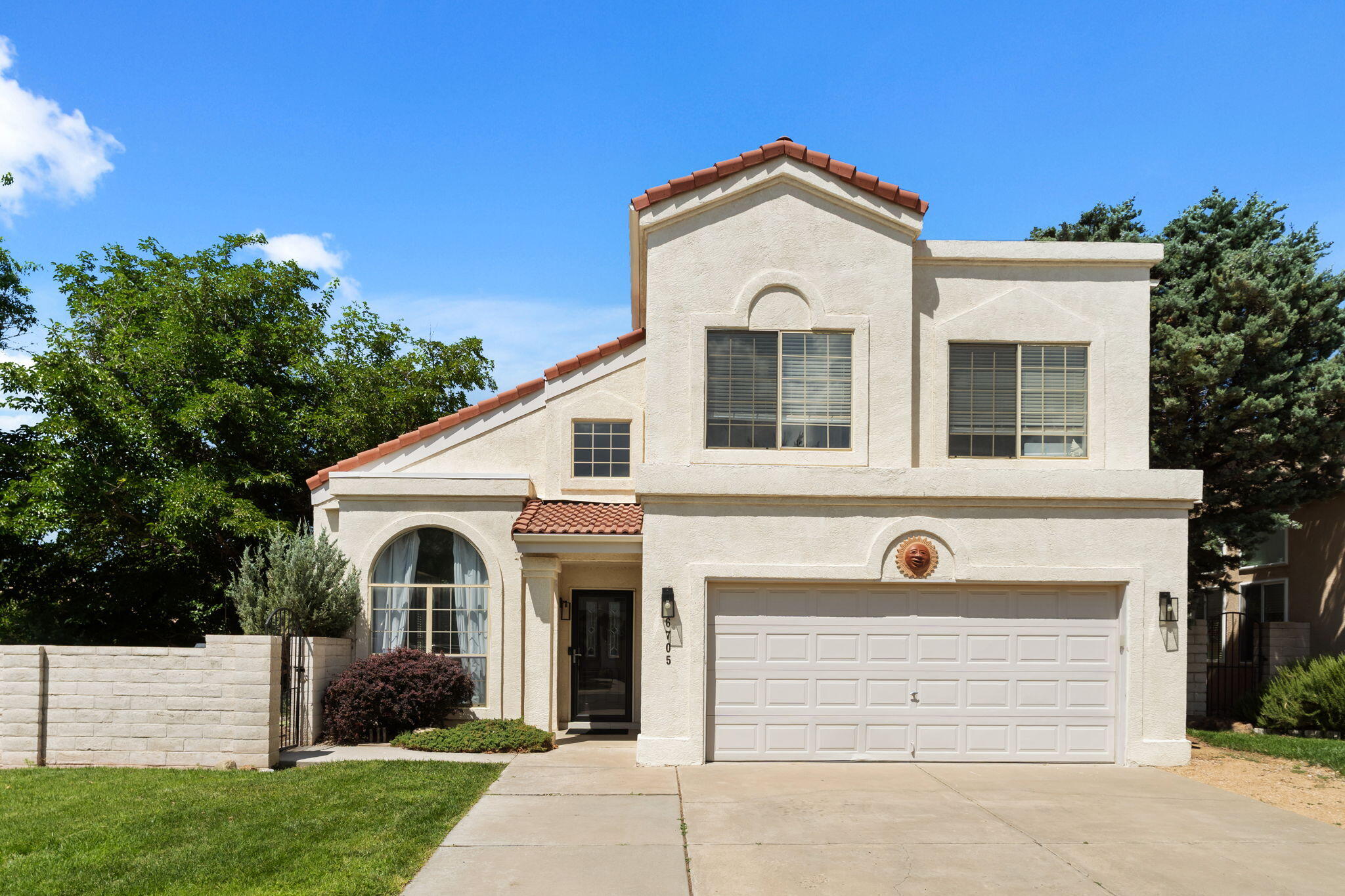 Located within the gated community of Tanoan West, this beautifully maintained 4-bedroom, 3-bath home offers 2,852 square feet of comfortable living with multiple gathering spaces and an incredible backyard oasis. The open kitchen opens to the main living area featuring a cozy fireplace, built-in shelving and abundant natural light. The luxurious primary suite boasts a stunning spa-inspired bathroom with a freestanding soaking tub, oversized walk-in shower and designer finishes. Enjoy formal and casual living areas, a spacious game/media room, 2-car garage and a private backyard shaded by mature trees with multiple patios, fire pit and plenty of room to relax or entertain. Just minutes from Tanoan Country Club and golf.