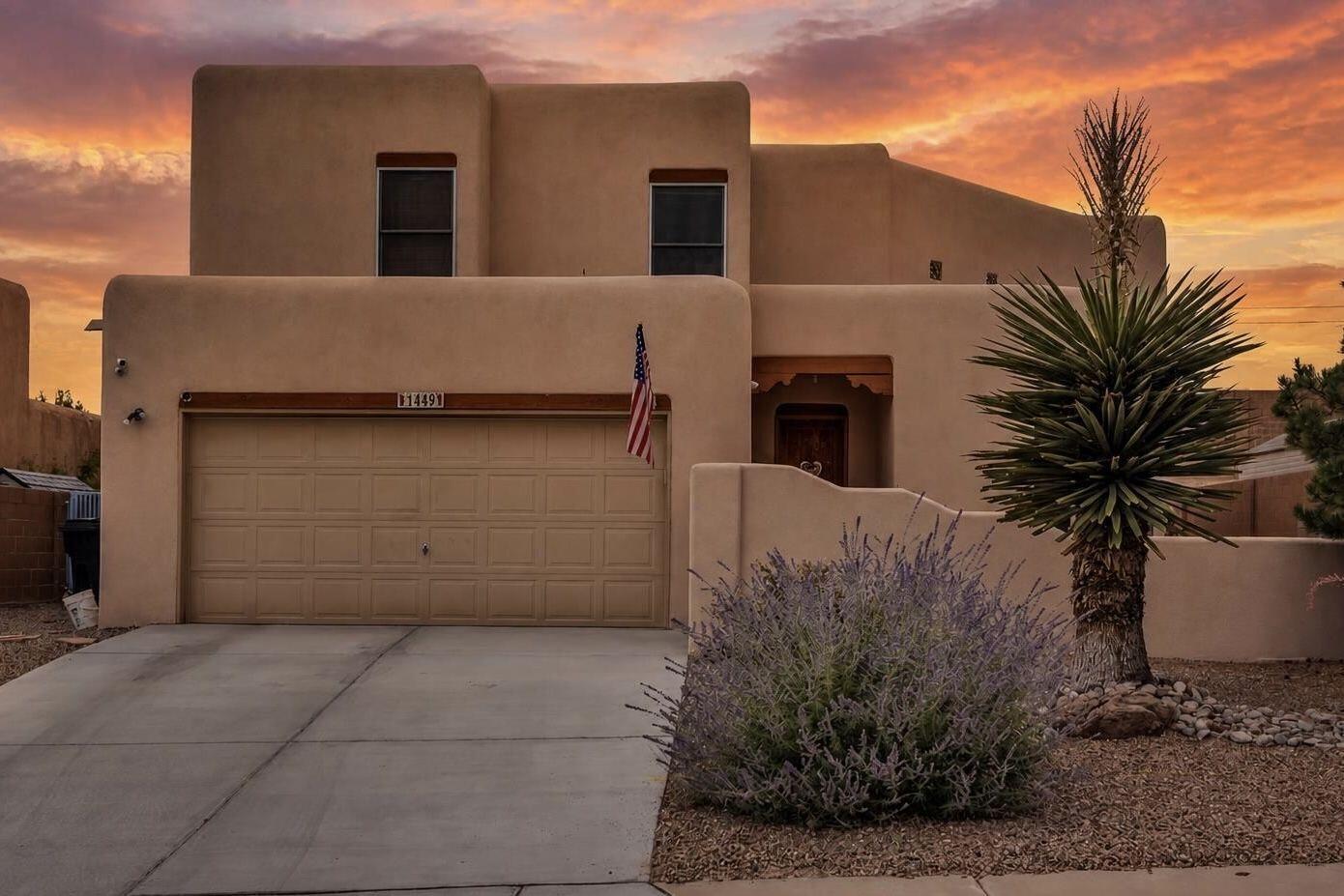A balcony made for Balloon Fiesta mornings, a courtyard that glows at dusk, and a soaring great room centered around a kiva-style fireplace. 1449 Wilkes Way is anything but ordinary. This distinctive semi-custom Tiffany home in Trinity Estates offers 3 bedrooms, 2.5 baths, flexible living spaces, and inviting indoor-outdoor areas designed to be enjoyed throughout the year.Step through the courtyard entry into a light-filled interior where the two-story great room immediately draws your eye upward. The fireplace brings warmth and unmistakable Southwestern character, while large windows and an open connection to the kitchen and dining areas create an easy flow for everyday living and entertaining. The generous kitchen features gas cooking, a breakfast bar, abundant cabinetry, a three-door Frigidaire refrigerator, and a pantry enhanced with built-in wood shelving.A front flex room with a closet provides options for a home office, formal dining area, hobby room, guest space, or another use that fits your lifestyle. Upstairs, the spacious primary suite opens directly to the covered balcony, a peaceful place for morning coffee, sunset views, mountain scenery, and the color of Balloon Fiesta season. The primary bathroom offers dual sinks, a soaking tub, separate shower, and ample storage. Additional rooms provide space for guests, work, or everyday needs without forcing the home into a single layout.The outdoor spaces are among the property's most memorable features. The covered upper balcony includes a lattice cover and built-in food and drink ledges, creating a natural extension of the living space. Below, the covered patio is finished with bamboo blinds for added shade and privacy. The two-tier backyard offers mature landscaping, a fountain, multiple places to gather, and room to relax, garden, dine outdoors, or entertain. A finished two-car garage and expanded double driveway add practical convenience.The home has also benefited from a number of thoughtful improvements, including synthetic stucco installed in 2017, a kitchen disposal in 2018, a gas water heater in 2020, and a three-door refrigerator, gas dryer, furnace motor, and lower living-room blind replaced in 2023. The refrigerated-air motor and front double driveway were replaced in 2025. Ring doorbell and ADT security equipment are present; buyer to verify equipment, transferability, and any subscription requirements.With its architectural character, flexible spaces, elevated views, and multiple outdoor living areas, this home offers a refreshing alternative to the typical resale. Seller reports an existing 3.25% VA loan may be assumable by a qualified buyer, subject to lender, servicer and VA approval. Schedule a private showing and experience the details that photos alone cannot capture.