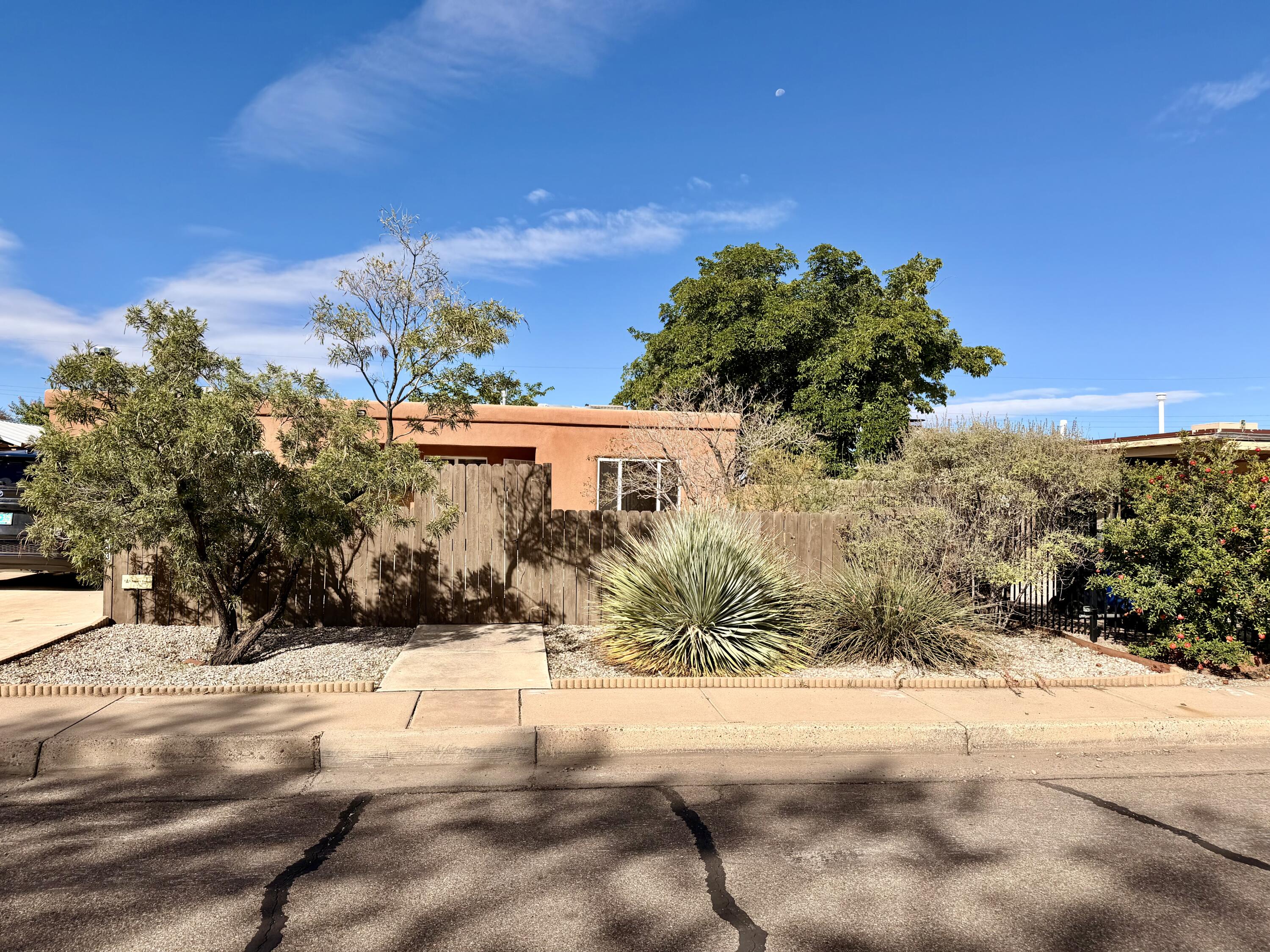 This charming, move-in ready home offers a comfortable and cozy layout in the highly desirable Uptown area of Albuquerque. Conveniently located near malls, restaurants, and everyday shopping, this 4-bedroom home (or 3 bedrooms with a flexible bonus room), 2-bath home is filled with natural light throughout.You'll appreciate the close proximity to parks, schools, along with everything the Uptown area  has to offer. Enjoy quick access to dining and grocery stores while still being tucked into an established, welcoming neighborhood. The home features paid-off solar for low electric bills, refrigerated air, abundant parking, side and backyard access, and no HOA. Step outside to a spacious backyard that offers a peaceful retreat, perfect for relaxing, entertaining, or creating your own outdoor oasis.Come take a look at this adorable single-story bungalow, this one won't last long!