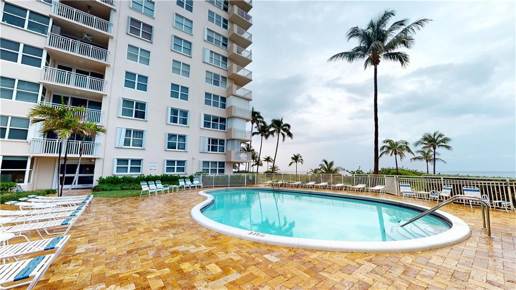 HEATED POOL ON SOUTH SIDE OF BUILDING OVERLOOKS THE LONG WIDE PRISTINE BEACH