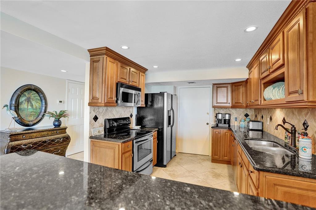 The kitchen door is another way to enter the apartment, and it leads out to the hallway, making for ease in dropping off groceries.