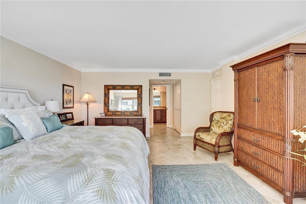 As you enter the primary bathroom, there is a walk in closet on the left, across from the other closet. The bathroom has a pocket door which slides into the wall and out of the way.