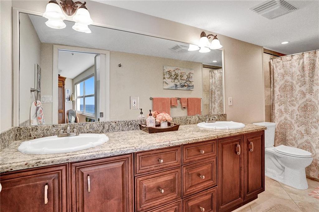 The primary bathroom has granite topped dual sinks, and lots of cabinet space.