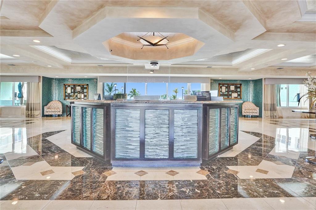 Southpoint has 24/7 security. The two luxury high rise towers are connected by this lovely lobby. A view out to the beautiful pool deck is visible.
