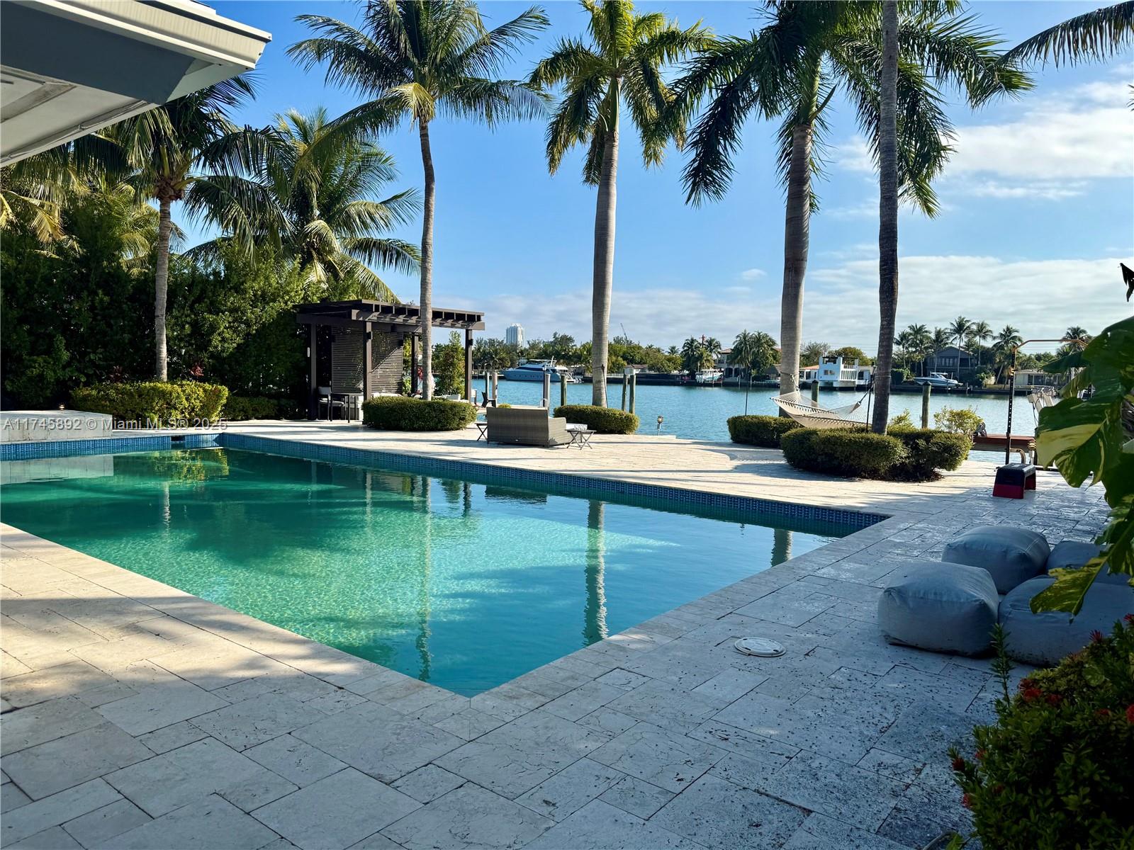 Don't miss this rare opportunity to own a prime open Bay views lot in Biscayne Point—an absolute paradise for boaters!This expansive 11,250 SF lot boasts a beautifully remodeled 3,850 SF, 4-bedroom, 3.5-bath home, updated in 2010. The open-concept design features a gourmet kitchen with Subzero appliances, a dining area, a breakfast nook, and a spacious living room with stunning Bay views.Move in as-is, customize the existing home, or build your dream waterfront estate. The outdoor space is perfect for enjoying Miami’s coastal lifestyle, complete with a large lap pool, gazebo, deep-water dock, boat lift, and no fixed bridges—ideal for yachts, speedboats, and jet skis.Schedule your private showing today!