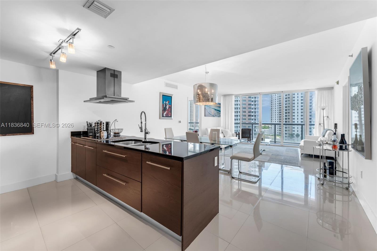 Wake up to breathtaking, unobstructed views of the water and the Miami skyline from this oversized 10th-floor corner unit at the prestigious Icon Brickell Tower 2. This rare layout features two spacious bedrooms plus a versatile den—ideal for a dedicated home office or a quiet reading nook. The interior emphasizes modern sophistication with uniform tile flooring, custom-designed master closets, and a premium Italian kitchen equipped with high-end appliances. Uniquely, this unit includes a parking space positioned on the same floor, offering a level of convenience seldom found in high-rise living. Beyond your front door, enjoy a resort lifestyle with access to a massive infinity-edge pool, a world-class spa, and a private movie theater. Located in the heart of Brickell, you are steps away from the high-end shopping at Brickell City Center and the vibrant energy of a walkway around Brickell Bay. Experience the best of Miami’s me