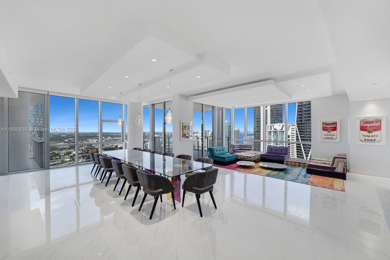 SELLER OFFERING ONE FULL YEAR OF HOA DUES PAID — A RARE OPPORTUNITY TO OWN WITH NO HOA COSTS FOR THE FIRST YEAR. NOW PRICED TO SELL.Paramount Miami, home to Miami’s largest amenity collection, presents its only combined residence: a one of a kind 4 bed 5 bath + den corner home over 4,500 SF. Near new and custom throughout, wrapped in glass with 3 balconies for skyline and bay views. Expansive great room, two separate family rooms and formal dining for large gatherings. The towers largest custom kitchen with premium appliances, double ovens, wine storage and oversized island. Grand primary suite with living area, dual walk-in closets, and luxurious bath. 10-foot ceilings, laundry room, 2 private elevator foyers. Furnishings by French design house Roche Bobois. Two side by side assigned spaces near the elevator plus valet; option to buy a third. Adjacent 2 bed 3 bath for sale next door (#4403) for guest quarters/office.