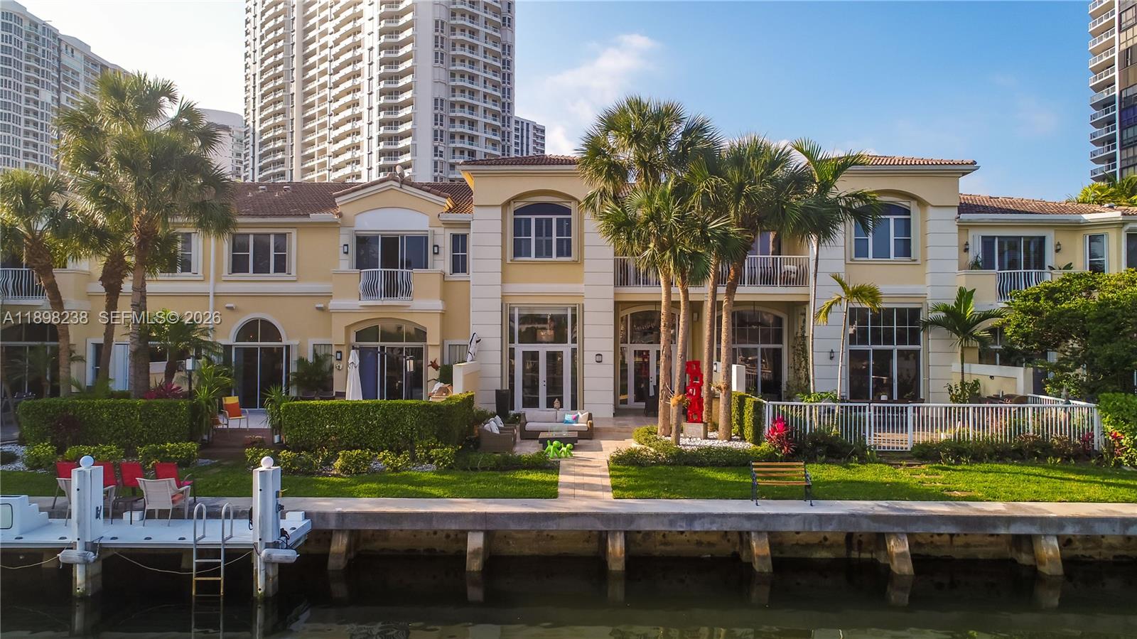 Welcome to an exclusive waterfront residence in The Courtyards at The Point! This expansive 4-bedroom, 4.5- bathroom townhome offers 3,200 sq ft of luxurious living in a gated community. Enjoy tranquil water views, private garage, and resort-style amenities including 3 pools, tennis courts, and a full-service fitness center. Minutes from Aventura Mall, top schools, and beaches. Foyer chandelier and exterior sculpture not included.