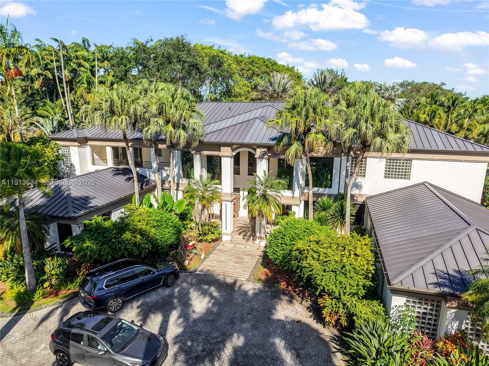 Expansive 10,000 SF Pinecrest estate set on a 65,776 SF lot, offering 7 bedrooms, 5 bathrooms with thoughtfully designed living and entertainment spaces. The residence includes a theater room, dedicated laundry room, and generous common areas ideal for large households or multi-use living. Outdoors, the property features a resort-style setting with a full kitchen/bar, tennis/basketball court, and a private lake. Additional highlights include a metal roof, full impact windows, and well-maintained interior and exterior conditions. A rare combination of scale, amenities, and privacy within one of Pinecrest’s premier residential neighborhoods.