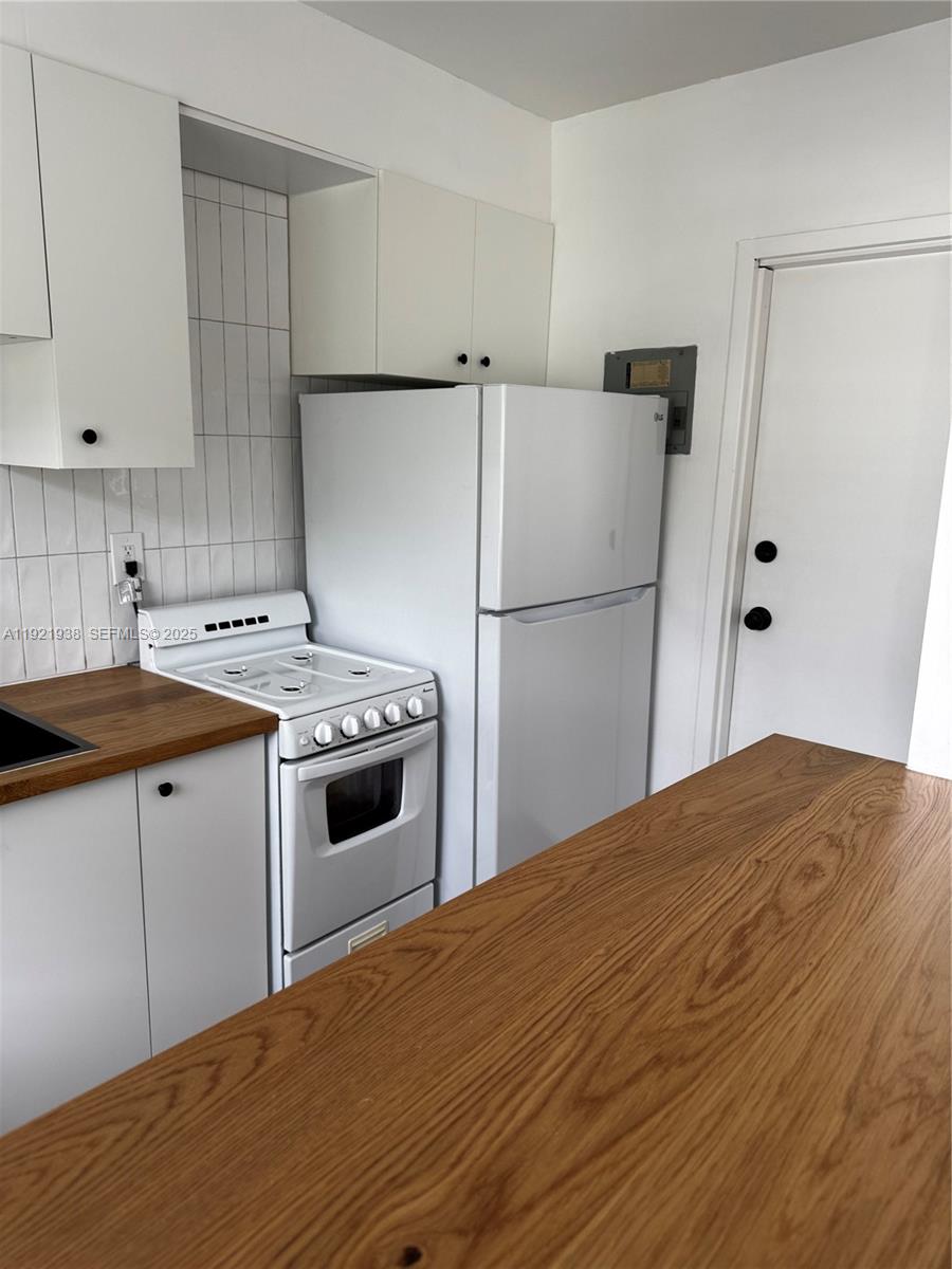 Modern kitchen with designer features at 725 91st St - Condo in Miami Shores