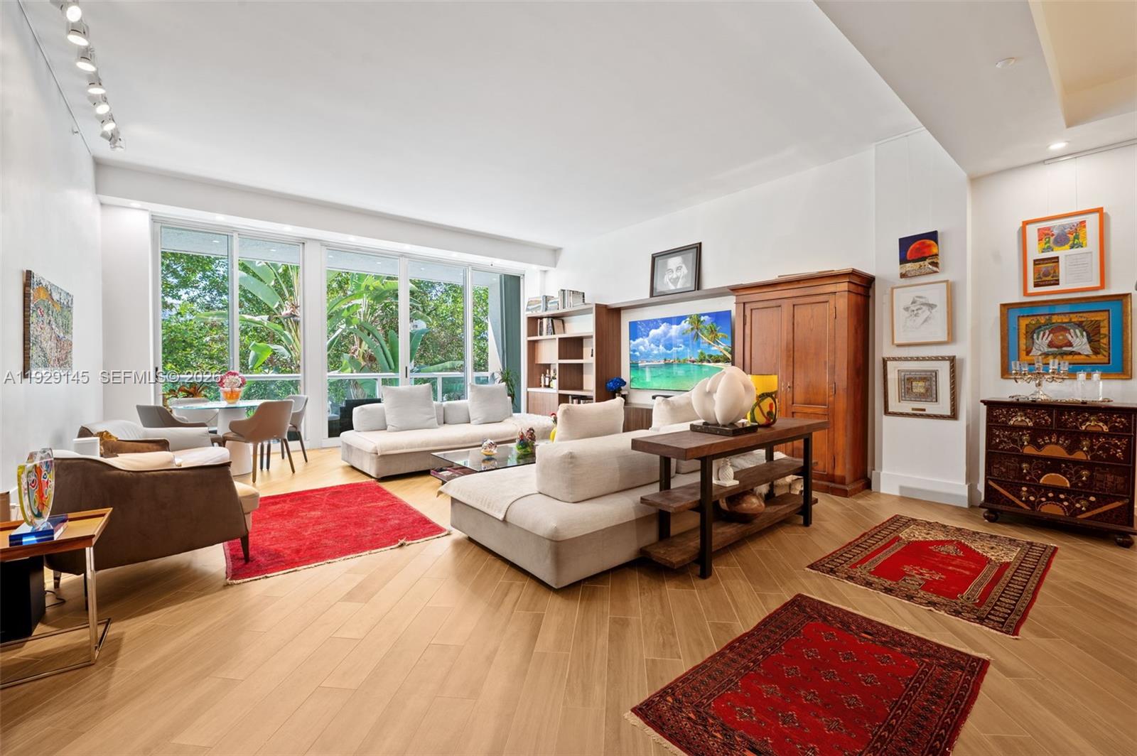 Stunning 3-story, 3,800 sq ft renovated townhouse offering an exceptional blend of modern luxury and architectural sophistication. This 3BR/3.5BA residence features beautiful porcelain flooring, soaring high ceilings, and a breathtaking atrium that floods the home with natural light. A newly installed private in-unit elevator provides effortless access to every level.The home includes a versatile painting studio/office, extensive custom built-ins, and gallery-style art hanging systems throughout. The gourmet kitchen is fully updated with new appliances and premium finishes, perfect for both everyday living and entertaining.Located in a resort-style community with unmatched amenities: clubhouse, on-site restaurant, beach service, heated pool, tennis and racquetball courts, and more. A rare offering combining space, style, and incredible lifestyle amenities—move-in ready and truly one of a kind.