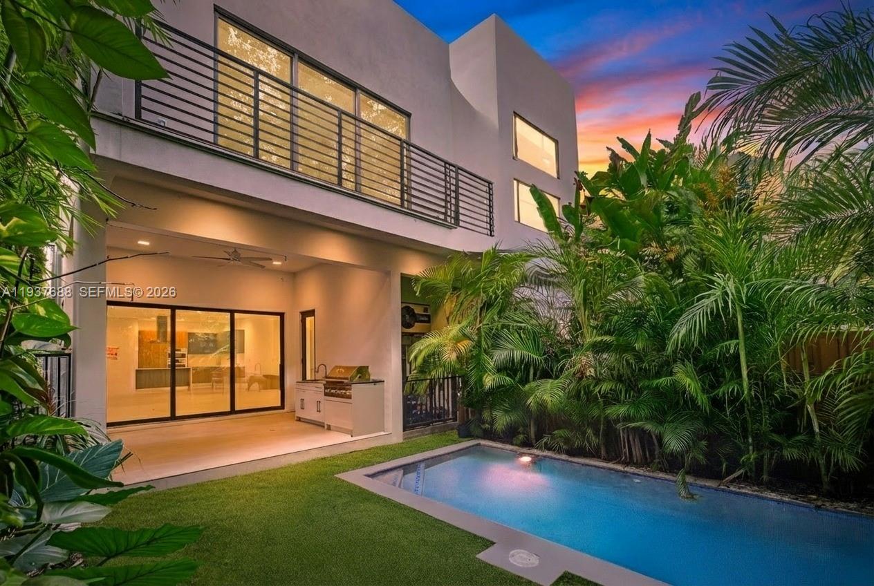 Tucked behind a private gate on a quiet Coconut Grove street, this 2022 contemporary townhome delivers architectural edge with effortless luxury tropical living. With 4 bedrooms and 5 full bathrooms, it's all about the Grove lifestyle. Inside, the natural light-filled open floor plan is framed by floor-to-ceiling impact glass and clean modern lines. The kitchen is the heart of this home with Italian Pedini cabinetry, Bosch stainless appliances, quartz counters, and a host-ready layout (or the perfect spot for a calm morning espresso). Smart-home features, electric blinds, dual-zone A/C, Tesla Charger in garage, and spa-inspired baths add “new construction done right” ease. Outside is where it really shines. Step into your private resort: a heated pool that’s unusually generous for the area, tall lush tropical landscaping for privacy, and a covered outdoor dining area complete with summer kitchen BBQ that turns weeknights into weekends. A full cabana bathroom is positioned for effortless pool-to-living convenience. Guests stay comfortable and the interior stays pristine.Location-wise, it’s classic Coconut Grove: minutes to CocoWalk’s shops and dining, close to Dinner Key Marina, and near Peacock Park for that chill bayfront rhythm. Near parks, marinas, top schools, shopping, hospitals, and so much more!Welcome Home! This is Luxury Coconut Grove living, natural light, and a backyard that feels like it's own unique destination. Come live the life others dream of.
