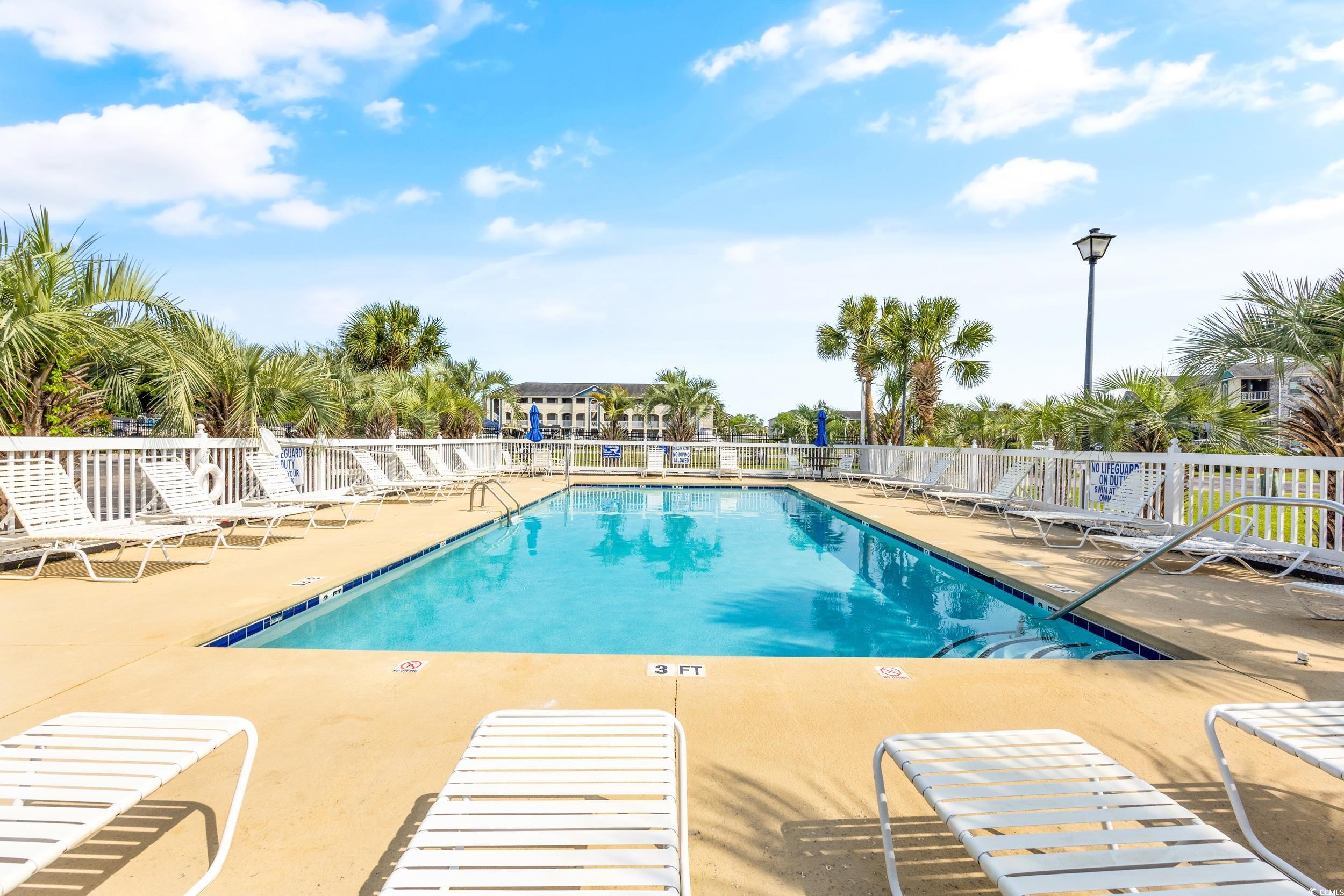 Community pool featuring a patio