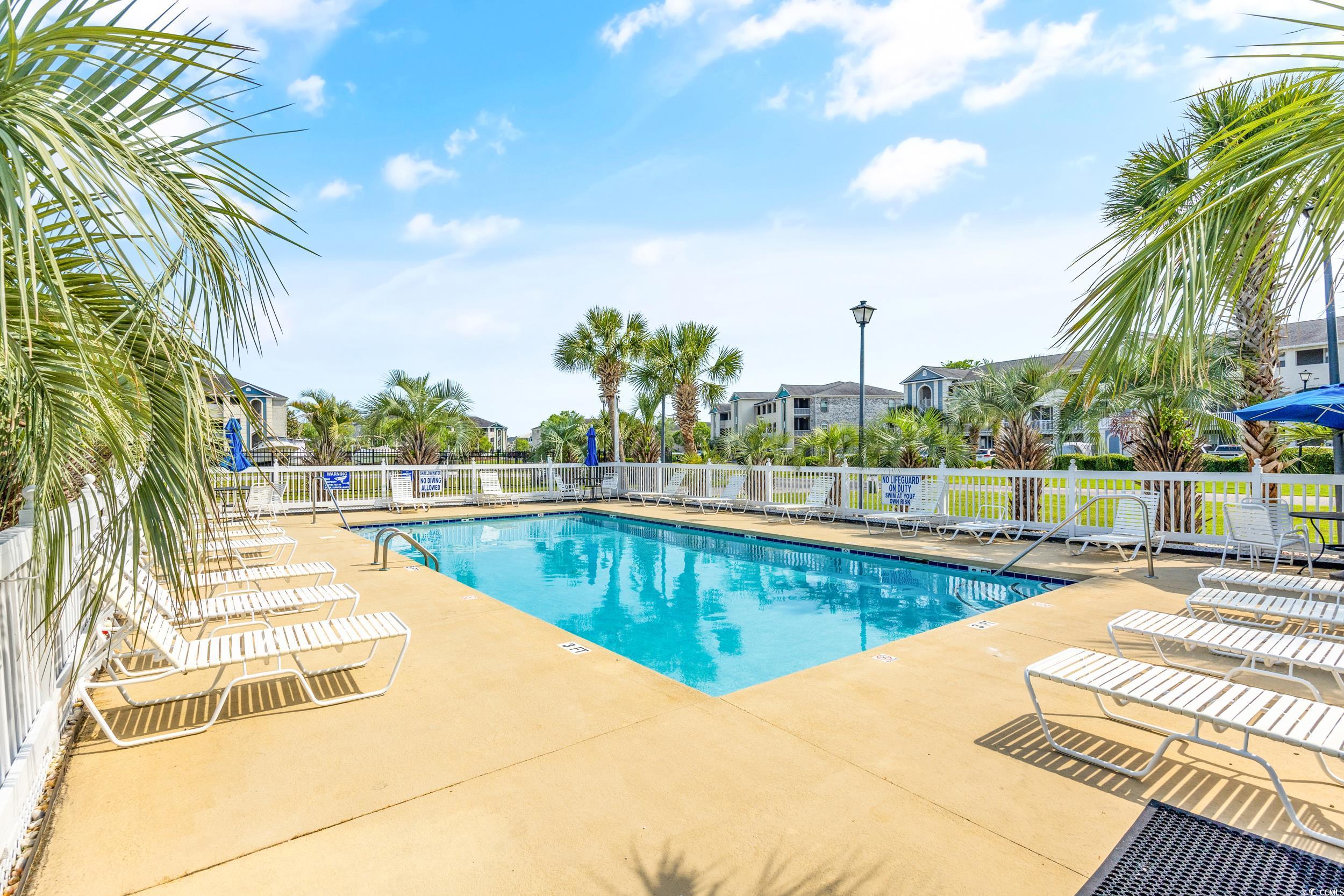 Community pool featuring a patio