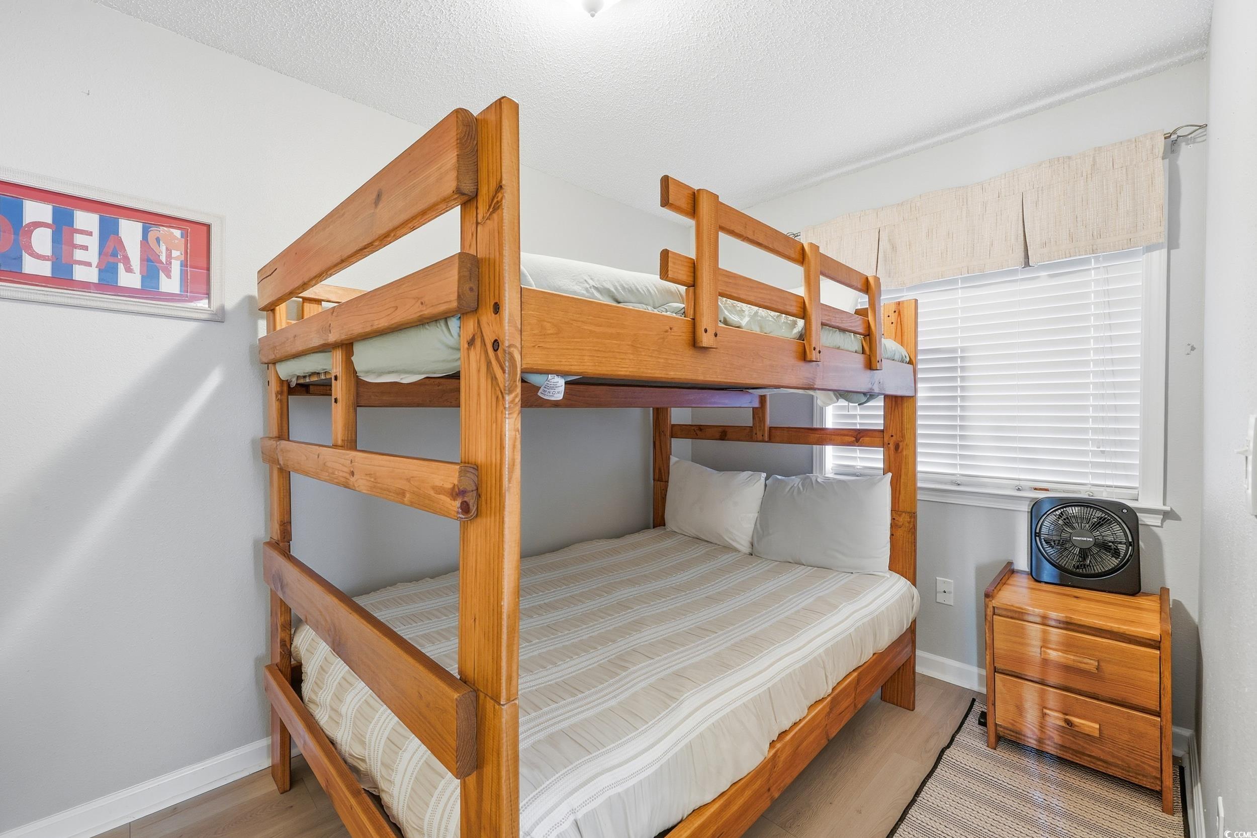 Bedroom featuring light wood-style floors and a textured ceiling