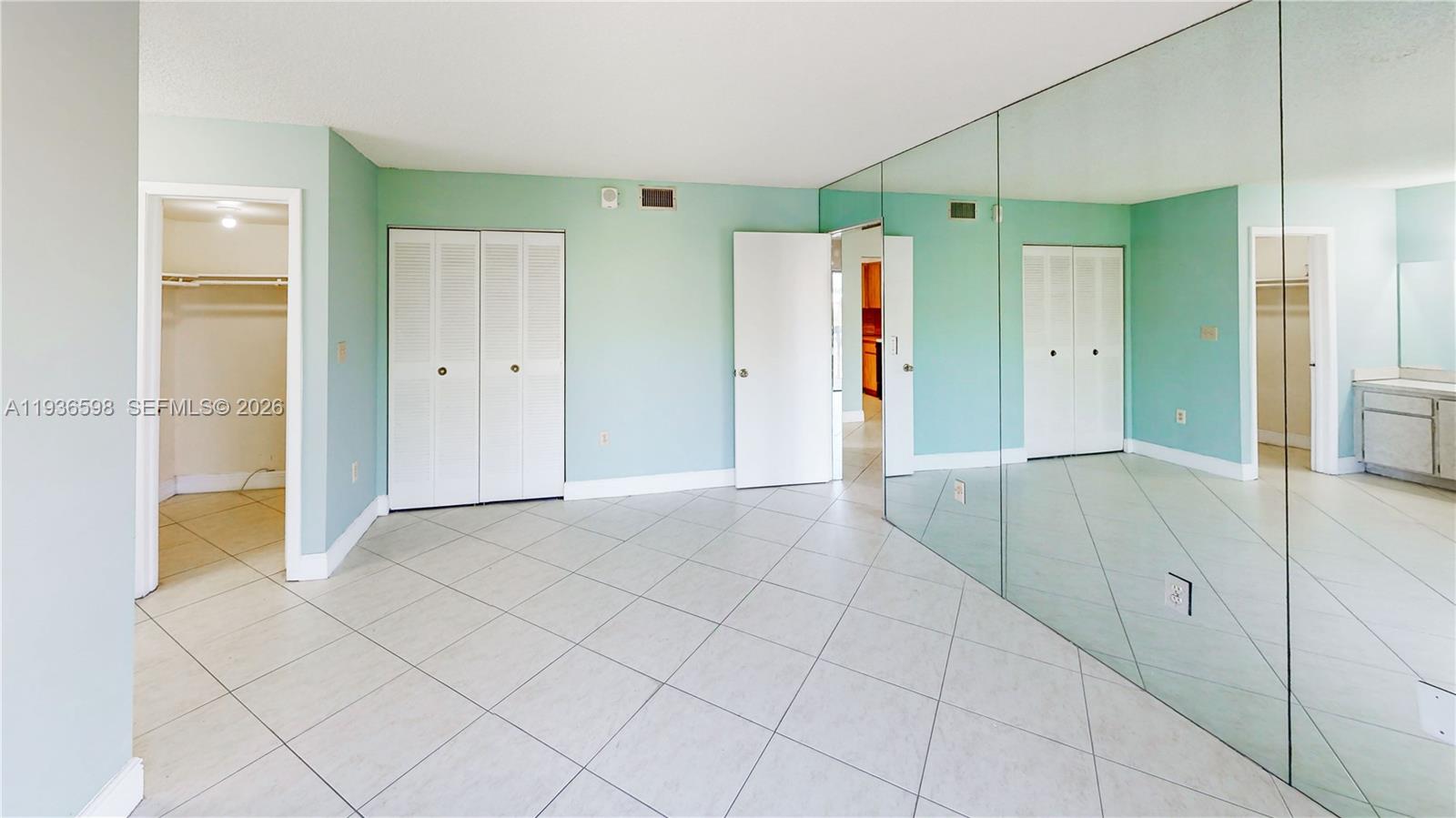 Well-appointed guest bedroom at 1300 122nd Ave - Condo in Miami