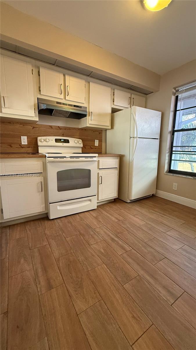Well-appointed guest bedroom at 201 Lake Pointe Dr - Condo in Oakland Park
