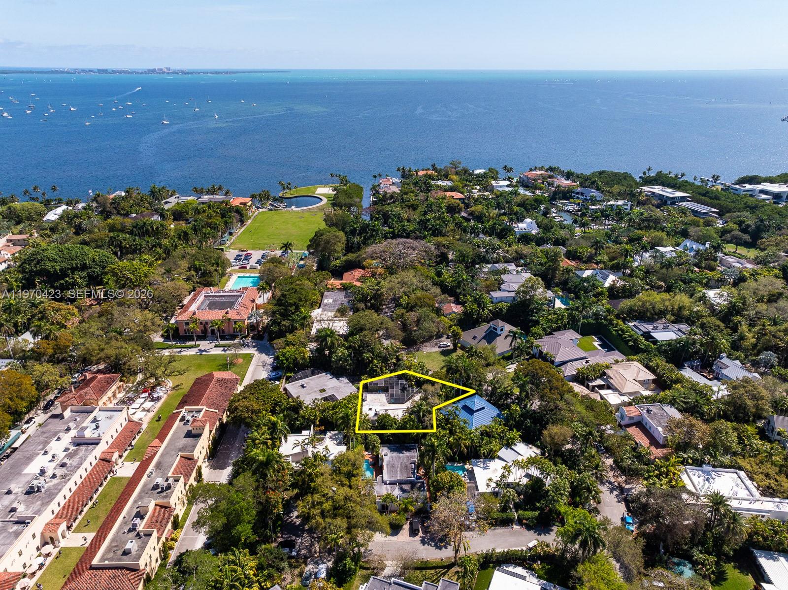 Step over the bridge and step back in time to this original, groovy Coconut Grove retreat. This super-fun 2-bedroom, 3-bath residence—complete with a home office, screened porch, and two-car garage—is ideally located within the exclusive 24-hour gated enclave of Four Way Lodge in the heart of South Coconut Grove. Offering approximately 2,000 square feet of living space on an 8,580-square-foot lot, the property is surrounded by lush greenery and mature foliage, creating a serene setting with excellent potential for future expansion. The kitchen opens to a delightful family room with views of a tempting pool—perfect for an afternoon or evening dip. Separate indoor and outdoor dining areas invite relaxed dinner parties under candlelight and stars. This home has character and endless possibilities. Get ready to reimagine and renovate this true Grove cottage to make it your own. Enjoy the benefits of being in Flood Zone X. Residents also enjoy a community boat basin with direct ocean access. A Very Special Home.