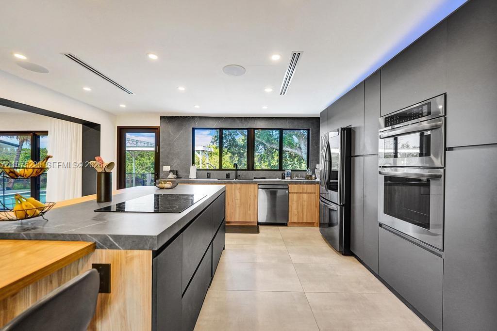 Modern kitchen with designer features at 4660 37th Ave - Home in Dania Beach