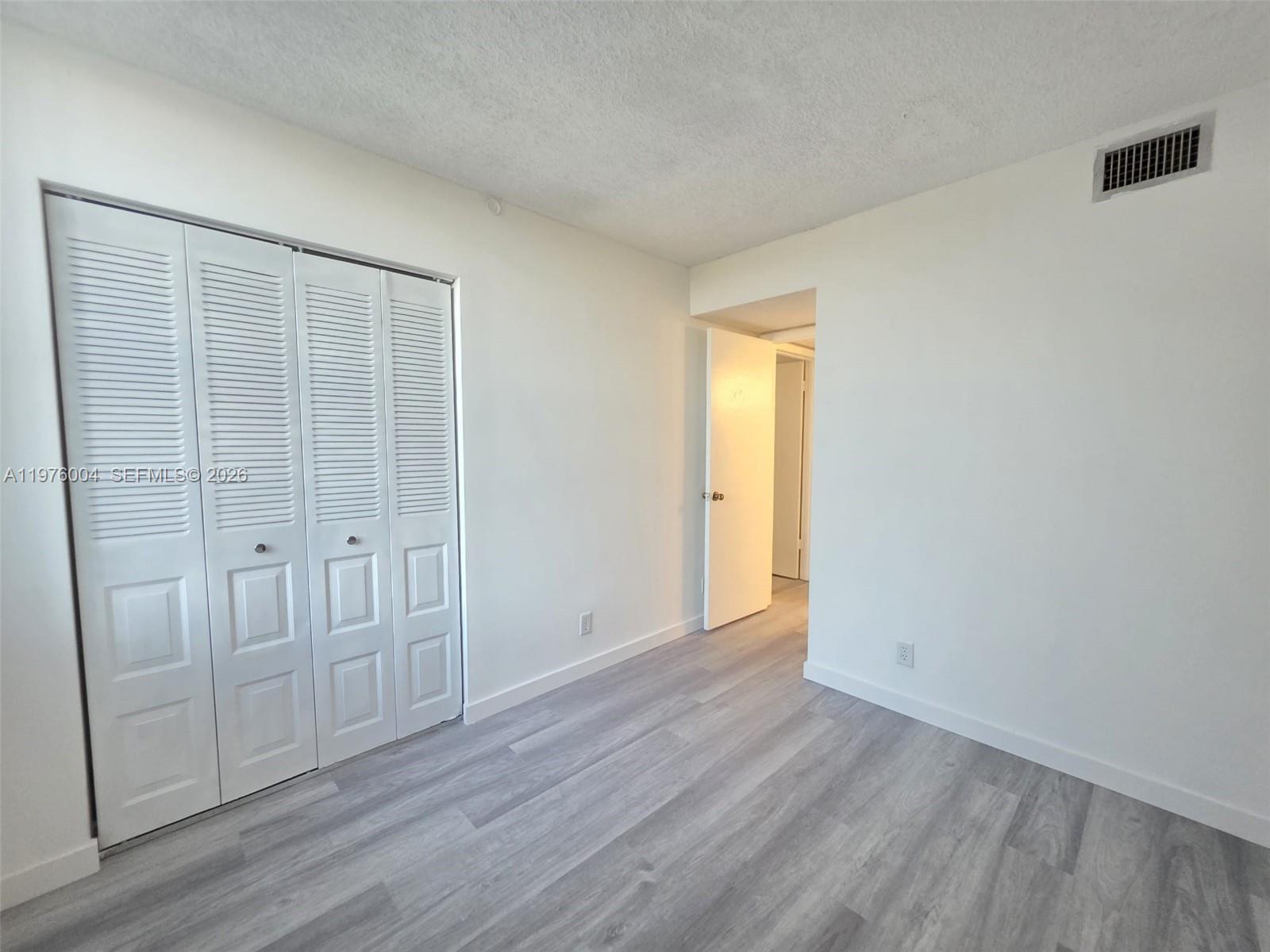 Well-appointed guest bedroom at 210 Lake Pointe Dr - Condo in Oakland Park