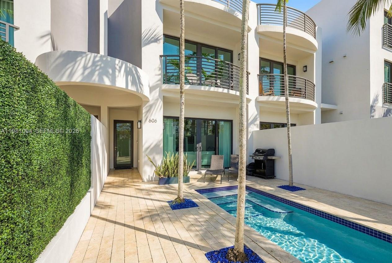 Situated in the sought-after Victoria Landing community in Victoria Park, just steps from Holiday Park and minutes to Las Olas, the beach, and Fort Lauderdale’s best dining and lifestyle, this tri-level townhome offers nearly 3,500 sqft under air.Featuring 3 bedrooms, 3.5 bathrooms, a private elevator servicing all floors, and a 2-car garage, the home offers spacious bedrooms, abundant closet and storage space, and upgraded porcelain tile flooring throughout.A private gated entry opens to a tropical courtyard with pool, lounge area, and BBQ, creating a true outdoor retreat. The main level features a bright open-concept layout with quartzite kitchen, bar seating, KitchenAid appliances, electric fireplace, and expansive sliding doors.The second level offers expansive bedrooms, a luxurious primary suite, and a flex space ideal for a home office.The entire third floor is designed for entertaining, featuring a third bedroom and a spacious entertainment loft with projector screen, built-in speakers, and a bar with wine cooler, opening to an expansive rooftop terrace overlooking Victoria Park and the city.