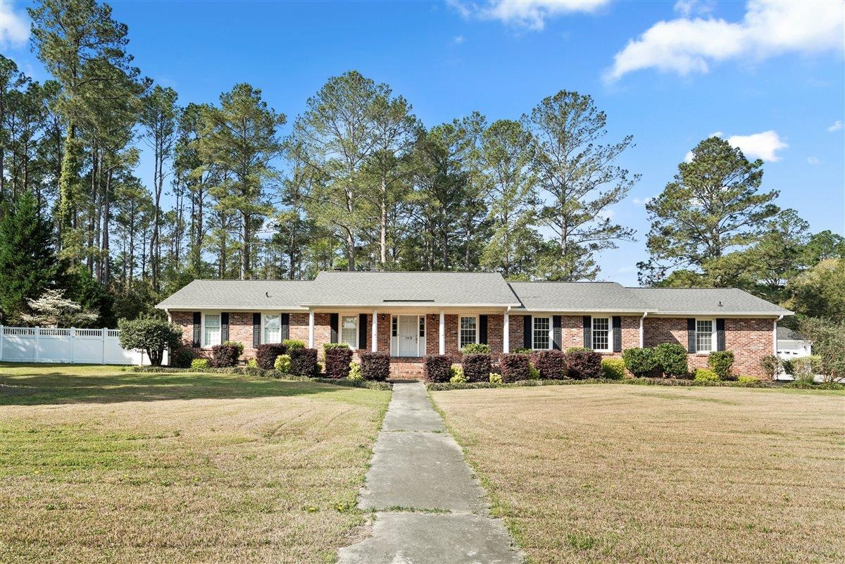 Step into timeless charm with this spacious, well-maintained home nestled on 1.04 acres in the beautiful Cheraw SC. Built in 1969, this property offers the perfect blend of classic character and functional living space - inside and out.  Featuring 3 bedrooms, 2 baths and 2392 sq ft, this home provides multiple living areas ideal for both everyday living and entertaining.  Enjoy a formal living room with fireplace, a cozy family room with gas log fireplace and a formal dining room perfect for gatherings.  The kitchen is equipped with stainless steel appliances, an alcove range, and a charming breakfast nook - the perfect spot to start your mornings.  Outdoor living is just as inviting with a welcoming front porch, covered patio and an additional uncovered patio for grilling or soaking up the sunshine.   Need space for hobbies or projects?  This property delivers!  You'll find a 2-bay workshop with upgraded electrical for welding, two exterior storage rooms, concrete RV pad and even a greenhouse for gardening enthusiasts.  Additional features include attached carport and ample yard space to enjoy peaceful country style living with room to grow in a desired neighborhood.   A rare find offering space, versatility, and classic charm - don't miss your opportunity to make this one your own!  MORE PHOTOS to Come