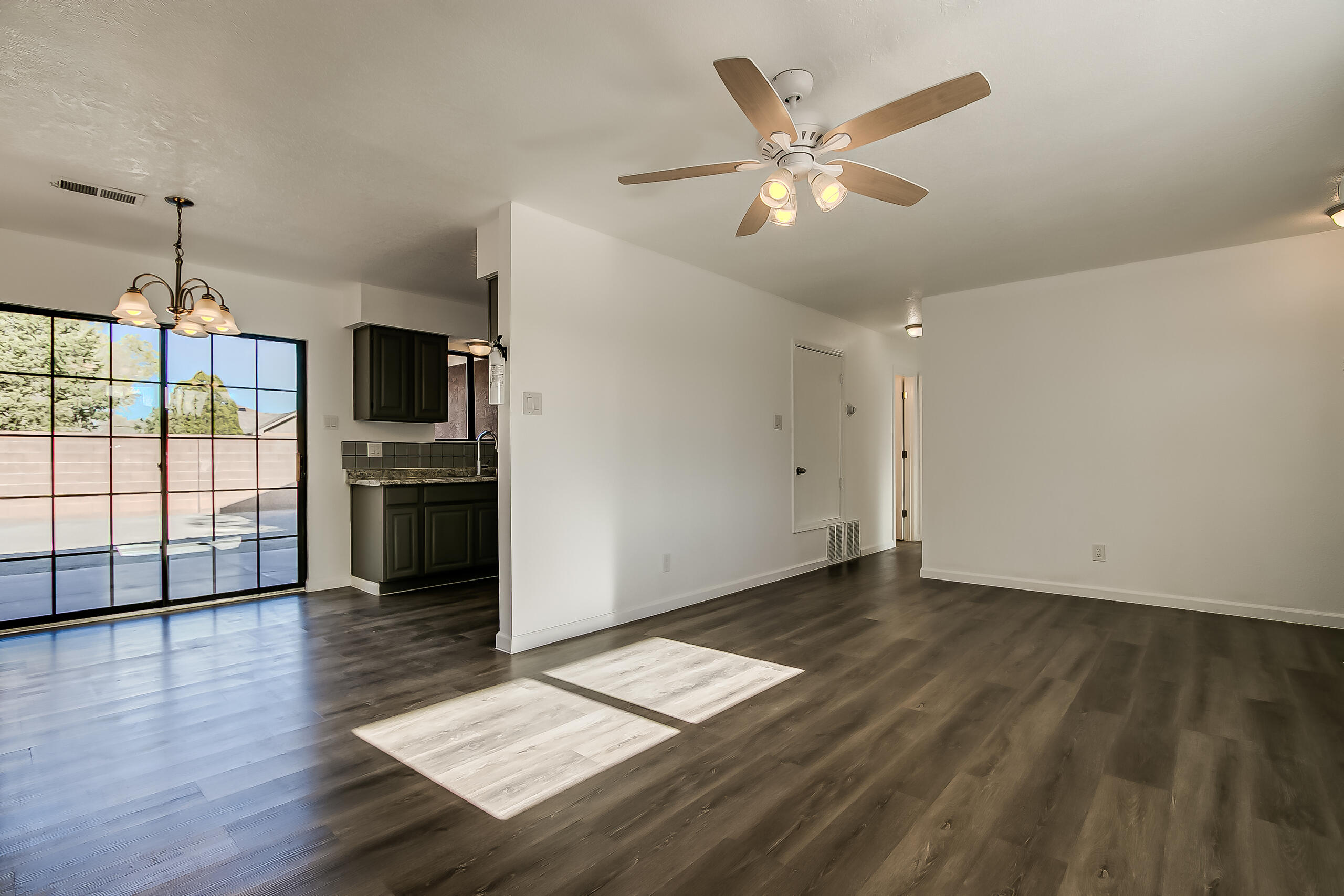 Charming Northern New Mexico style home in Albuquerque's desirable North Valley. This 3-bed, 2-bath home offers updated LVP flooring thru out, fresh interior paint, & abundant natural light. The kitchen features updated countertops, stainless steel sink, & custom tile backsplash, opening to the dining & living areas for a functional layout. Spacious primary suite incl ceiling fan, dbl closets, & full bath w/updated vanity, quartz countertop, & upgraded fixtures. Secondary bedrooms are generously sized w/ceiling fans. Updated full hall bath. Additional features include central forced-air gas heat, metal thermal dbl-pane windows, pitched metal roof, & low-maintenance xeriscaped front yard. Backyard offers expanded patio w/additional space extending to a second rear block wall.